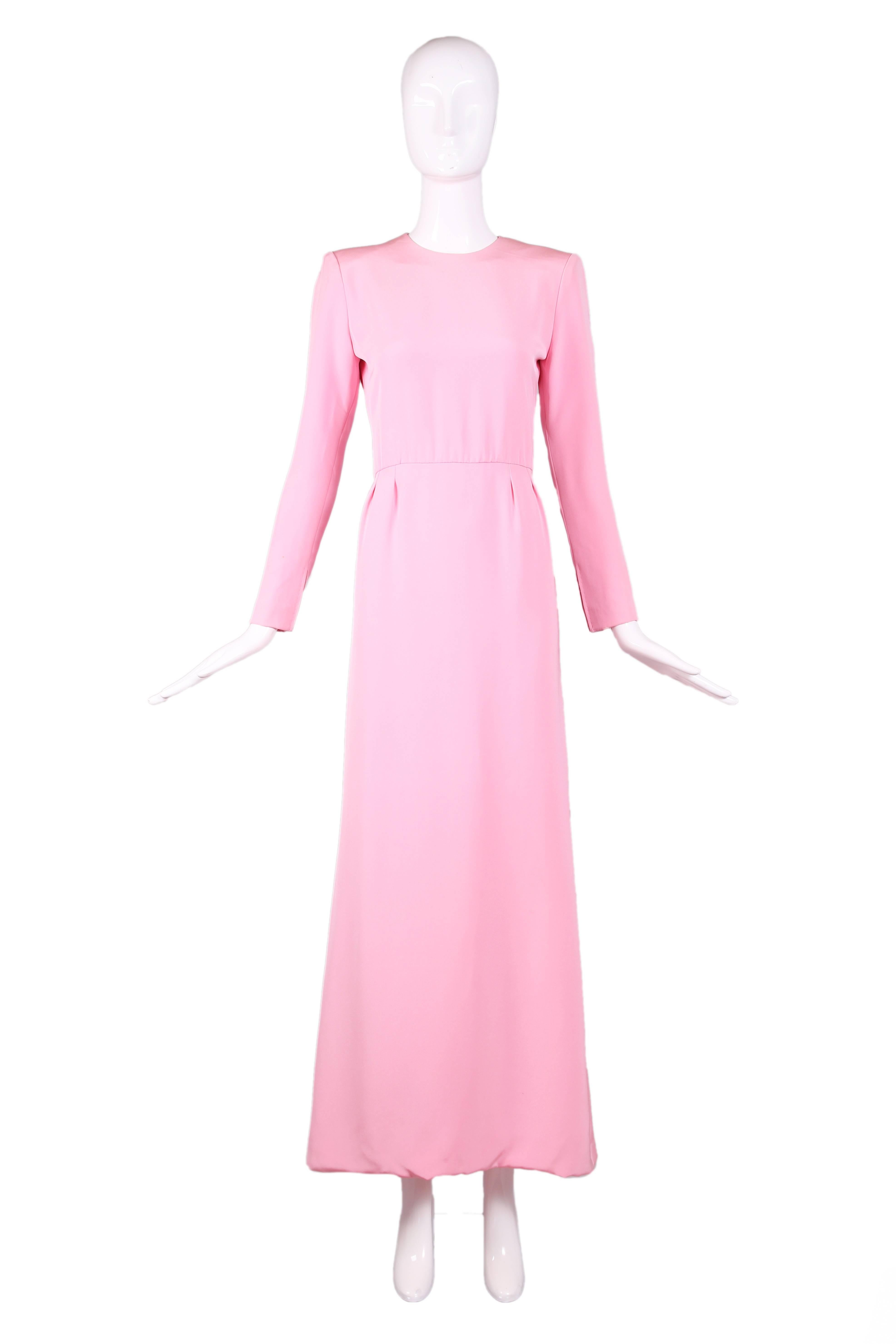 Vintage Pierre Balmain haute couture baby pink silk crepe A-line gown with long sleeves and jewel neckline. Features four pleats at waistline in front and back. Zipper closures both at bodice back and at cuffs. Fully lined in silk. In excellent