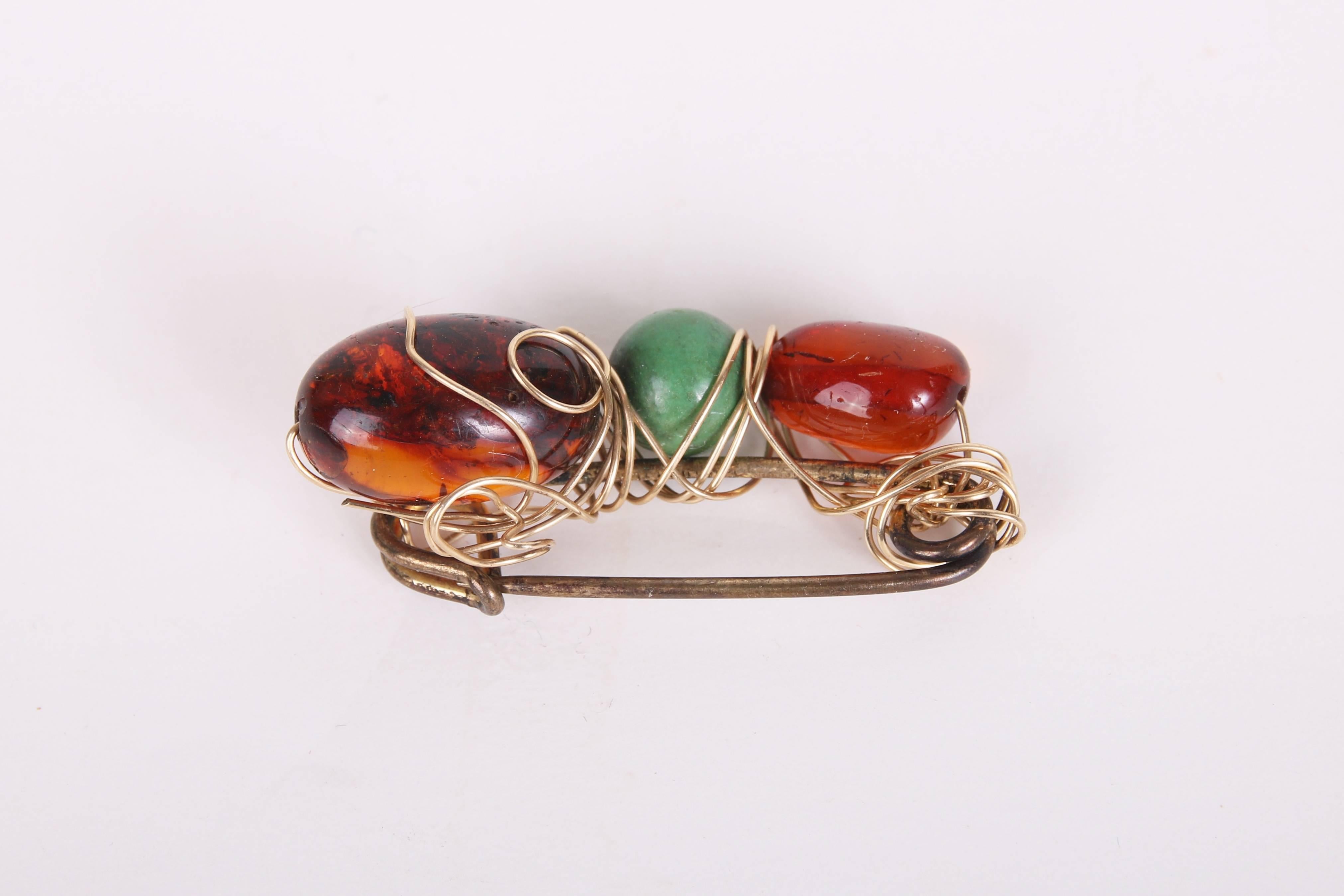 Kazuko 14k wire wrapped beaded safety pin brooch with three crystal beads - two brown and one green. In very good condition with some tarnish on the safety pin.
MEASUREMENTS:
Length - 1 5/8