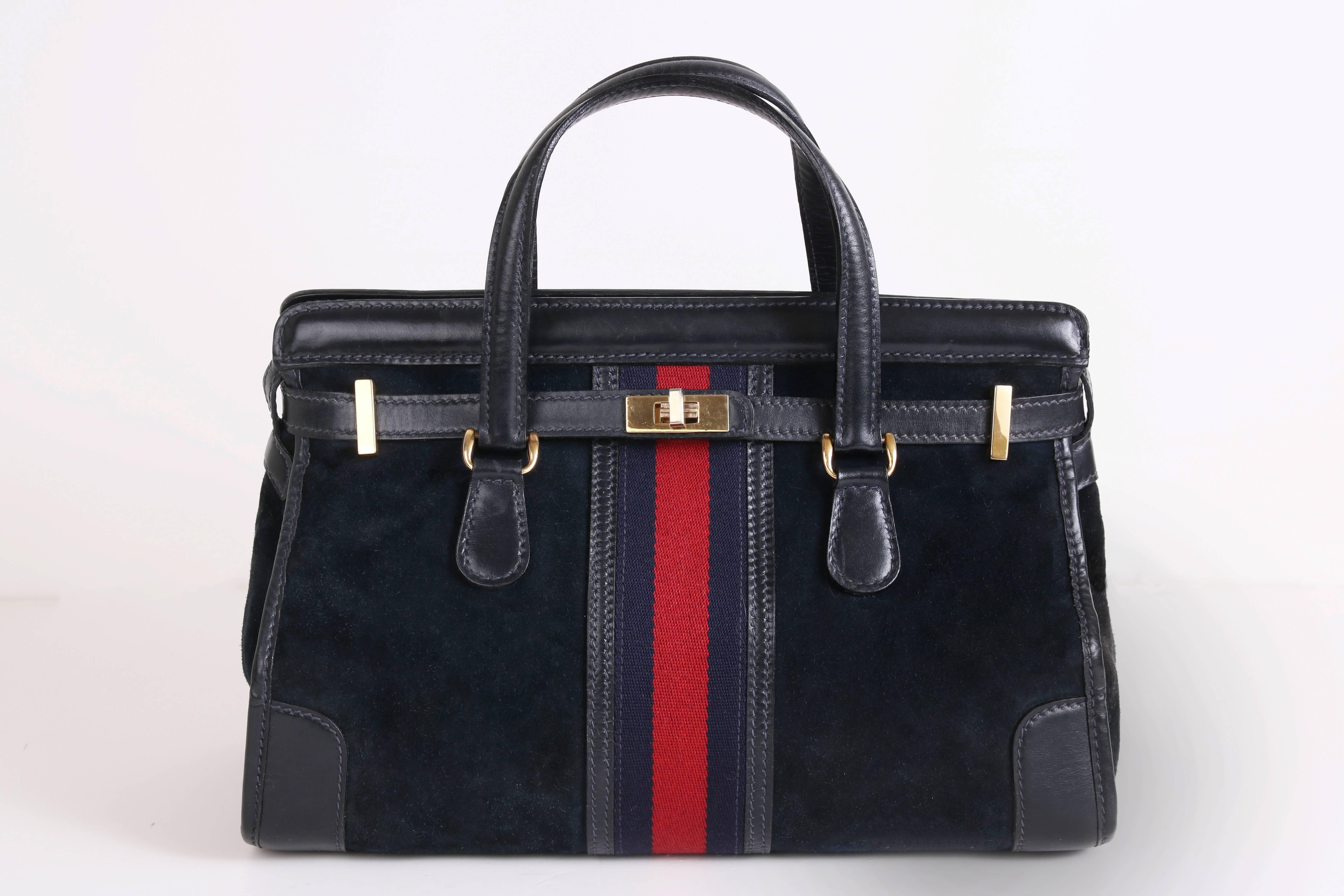 A rare 1970s Gucci navy blue suede open-top doctor's bag or tote with blue leather trim, gold hardware and iconic Gucci blue and red canvas racer stripe detail at center back and front. Features a wraparound blue leather strap, brass turn lock
