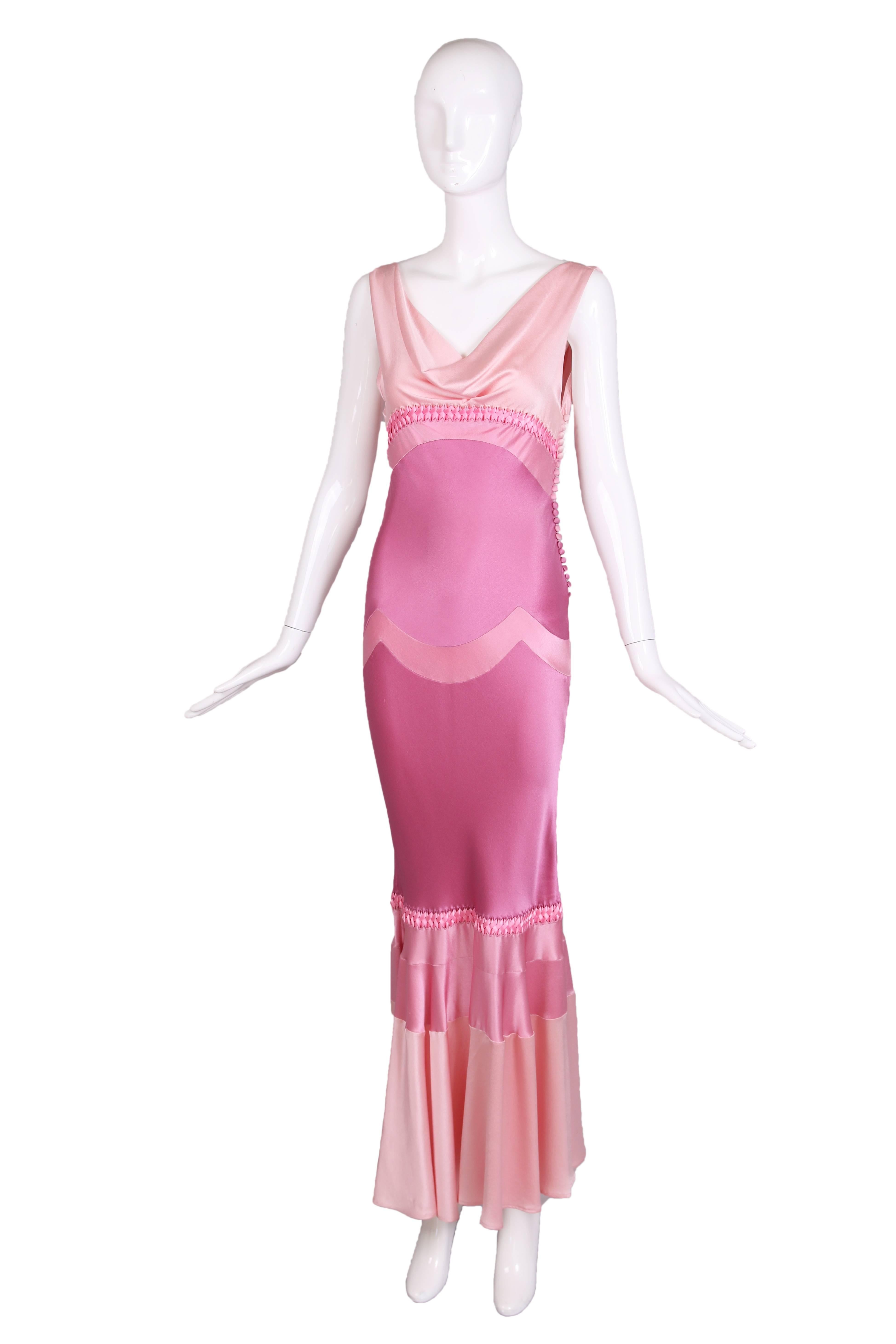 Christian Dior by John Galliano pink silk bias cut sleeveless gown with a cowl neckline, scooped back, and flared hem. This dress features a color blocking of different shades of pink and braided ribbon at bust and knee that circles around entire