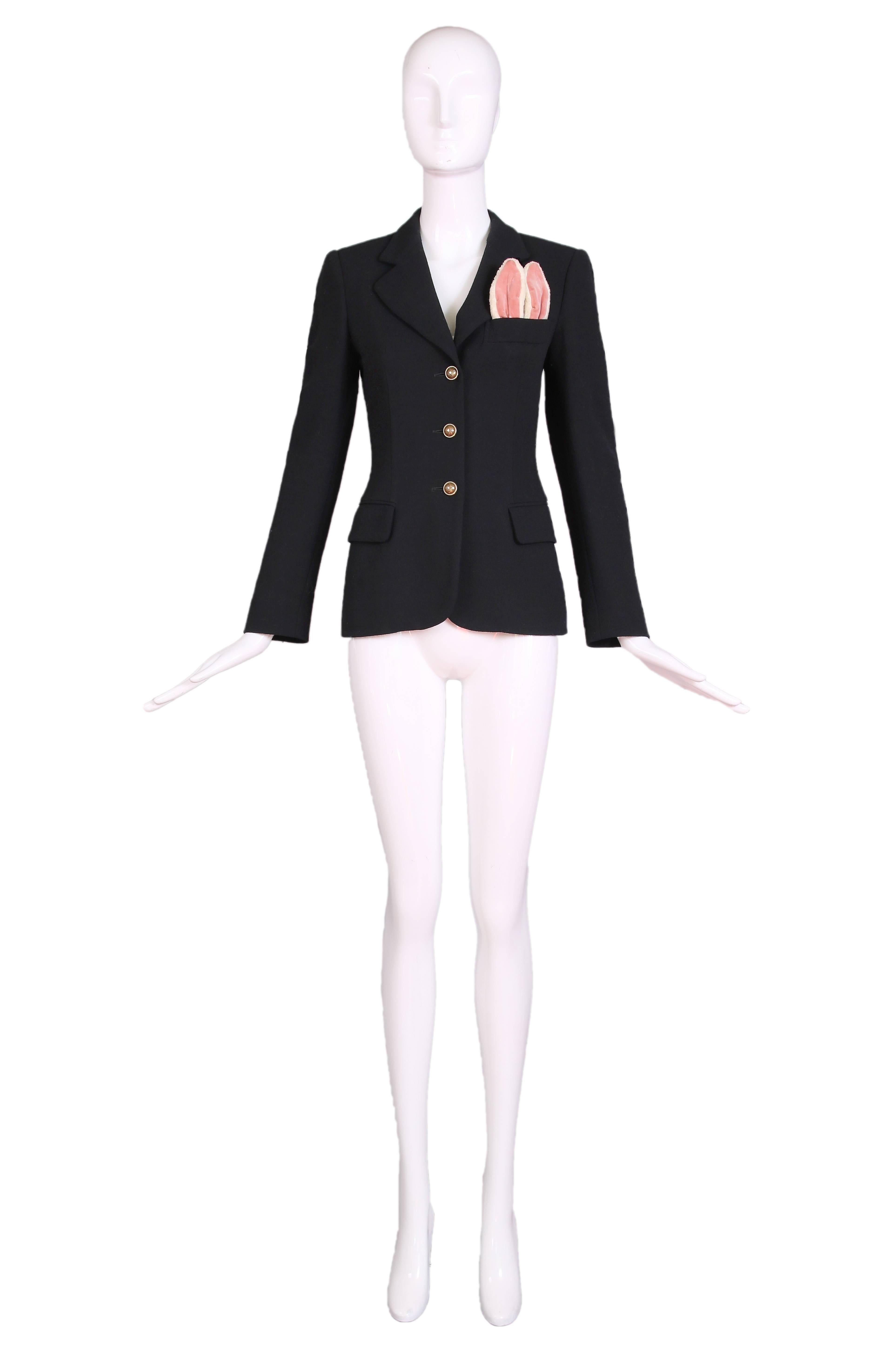 Vintage 1990's Moschino Cheap & Chic black wool blazer featuring beyond-adorable pink and white fuzzy bunny ears poking out of the top pocket. The blazer has two front pockets at the hip, a back vent, and three brass buttons down the front that