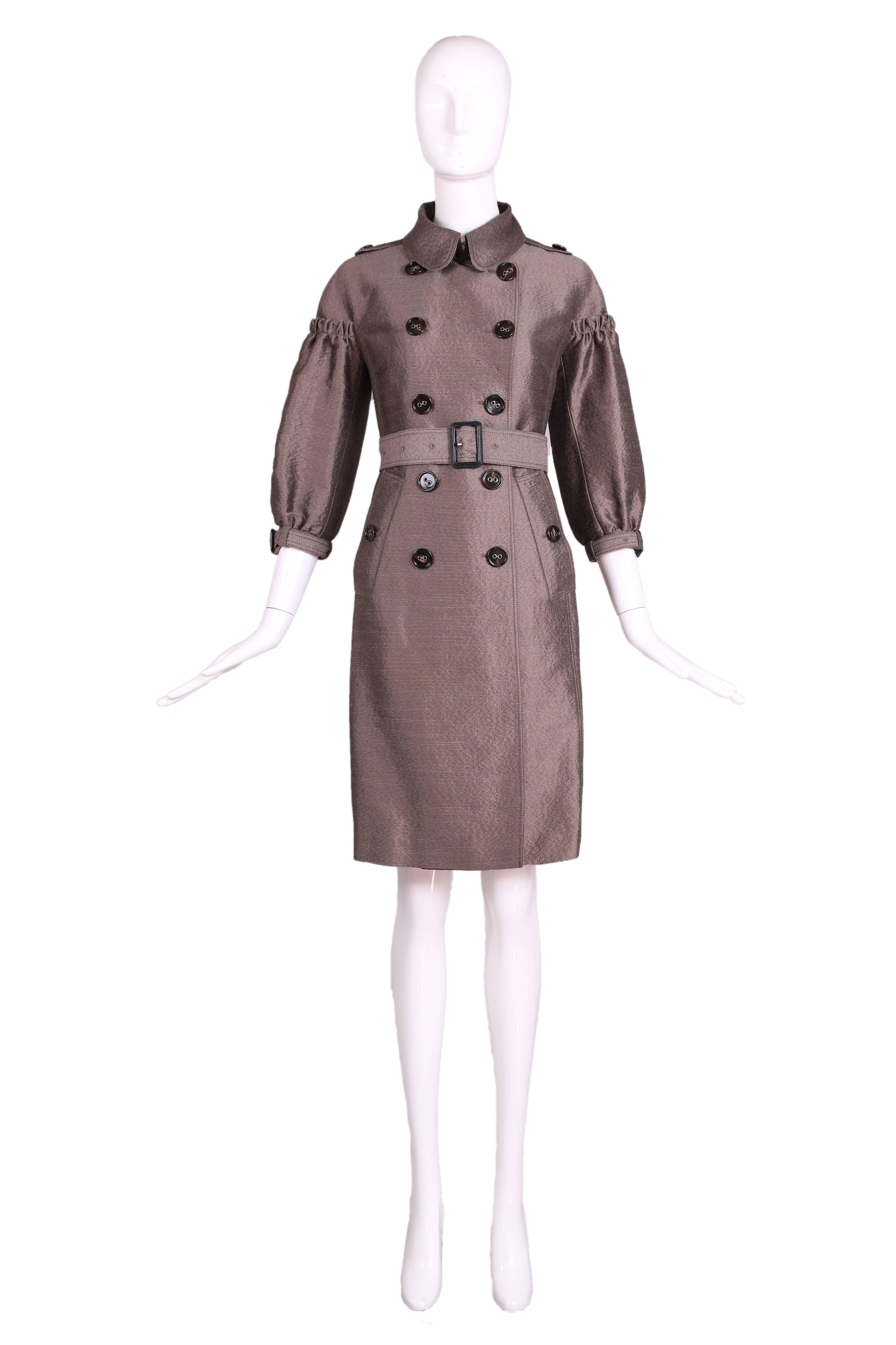 Burberry Porsum mocha colored trench coat with belt, 3/4 puffed sleeves and buttons down the front. Fabric is a silk and wool blend. Size tag 38 - please consult measurements. Coat is in excellent condition - missing a button at the
