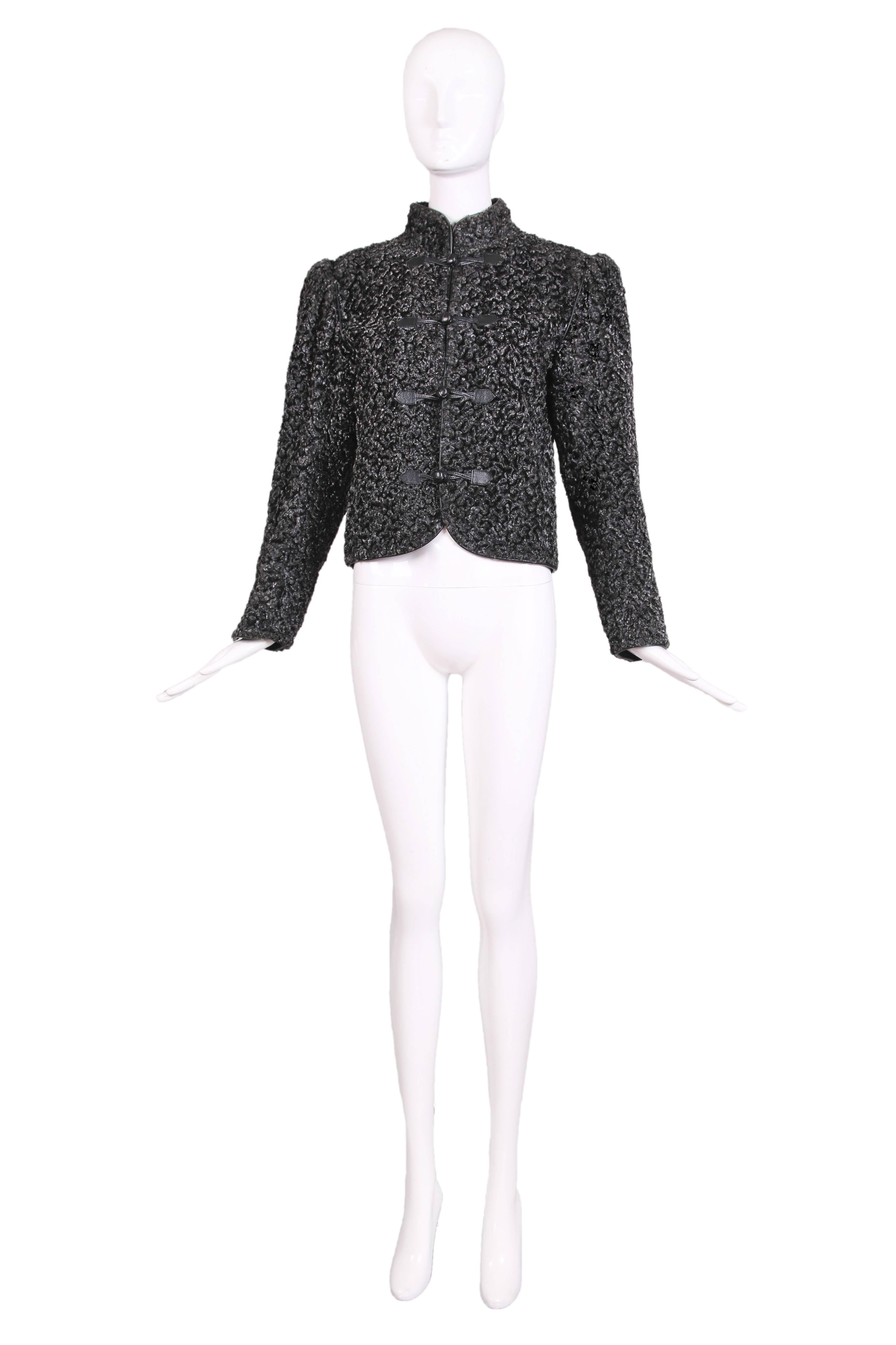 Yves Saint Laurent uncut broadtail fur jacket in the classic Russian style. This jacket has four leather loop and button closures and us trimmed in leather pipping. c.1970's 
Measurements -
Bust: 40"
Waist: 36"
Length: 20"
EU: 36
