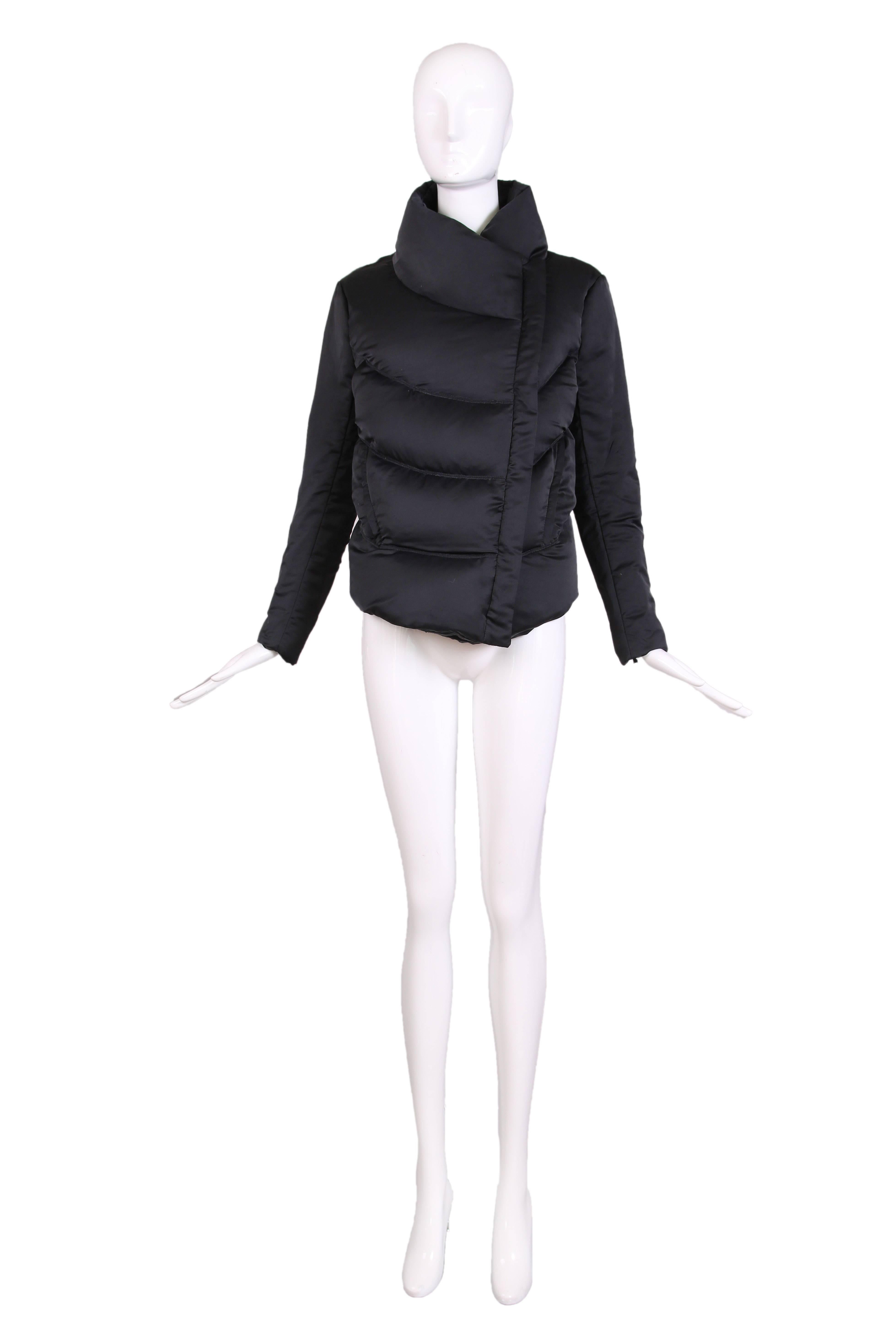 Helmut Lang black fitted puffer jacket with high collar and slim sleeves with zippers for a snug fit around the arms. There are side slit pockets with zip closures as well as a front zip closure. 

Measurements: 
Shoulders: 17