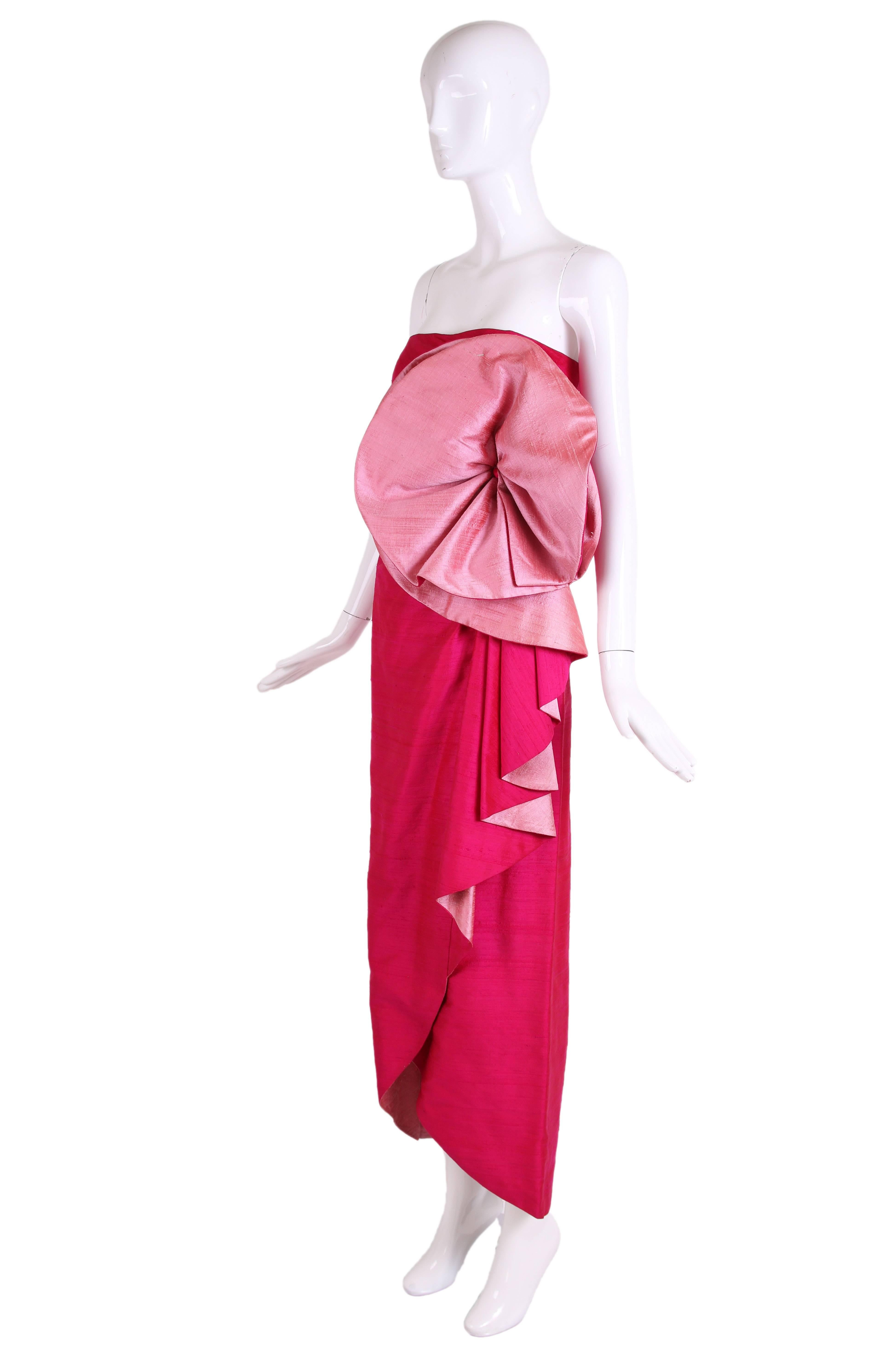 Circa 1980 Roberto Capucci fuchsia silk shantung strapless evening gown with oversized rosette at bust and draping down the front - comes with matching shawl/scarf. In excellent condition. Italian size 42. Please see measurements.
MEASUREMENTS:
Bust