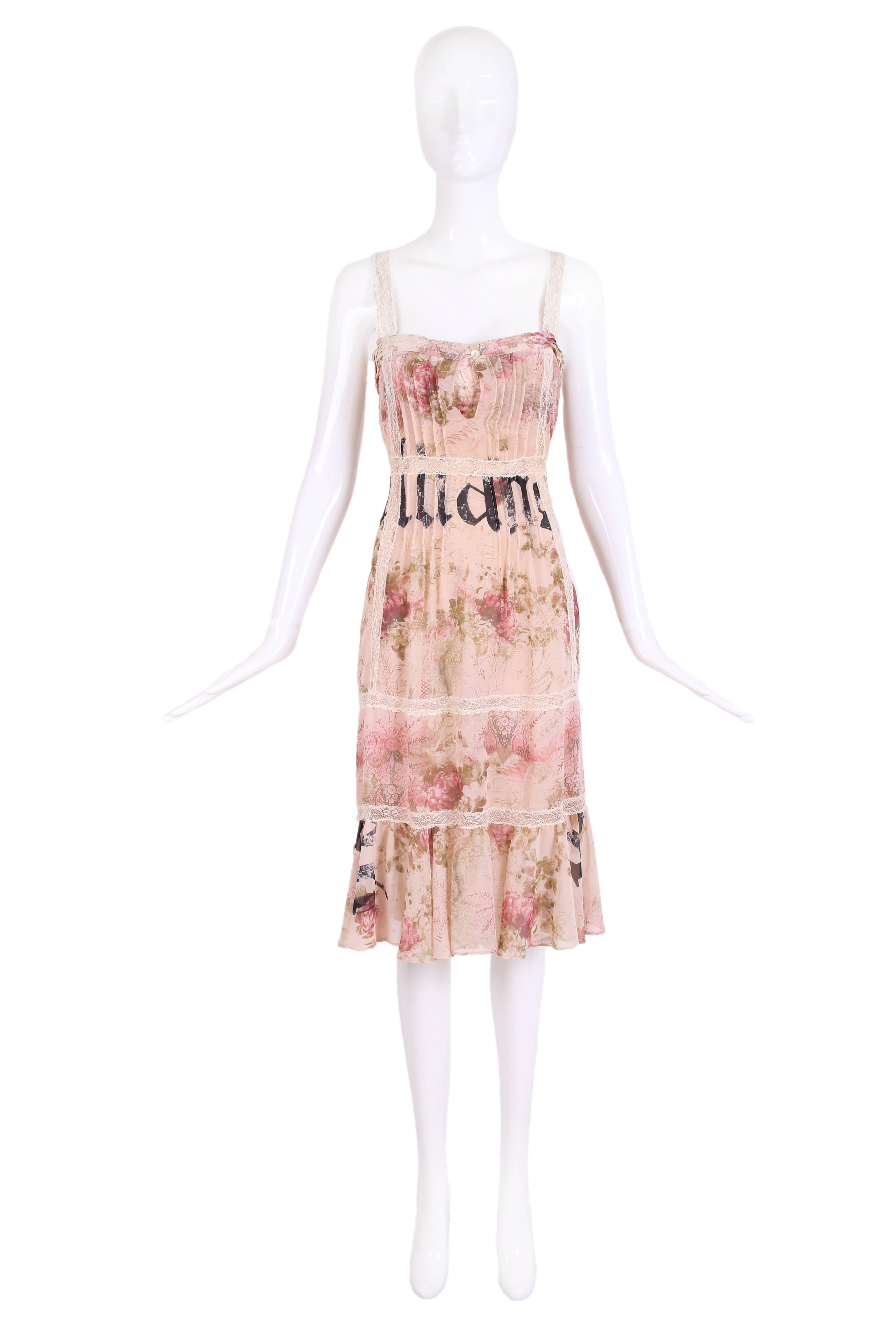 John Galliano rayon floral and signature dress with built in bra. Dress has cream lace insets, pintuck detailing and a soft ruffle flounce hem. In excellent condition. Size 40.