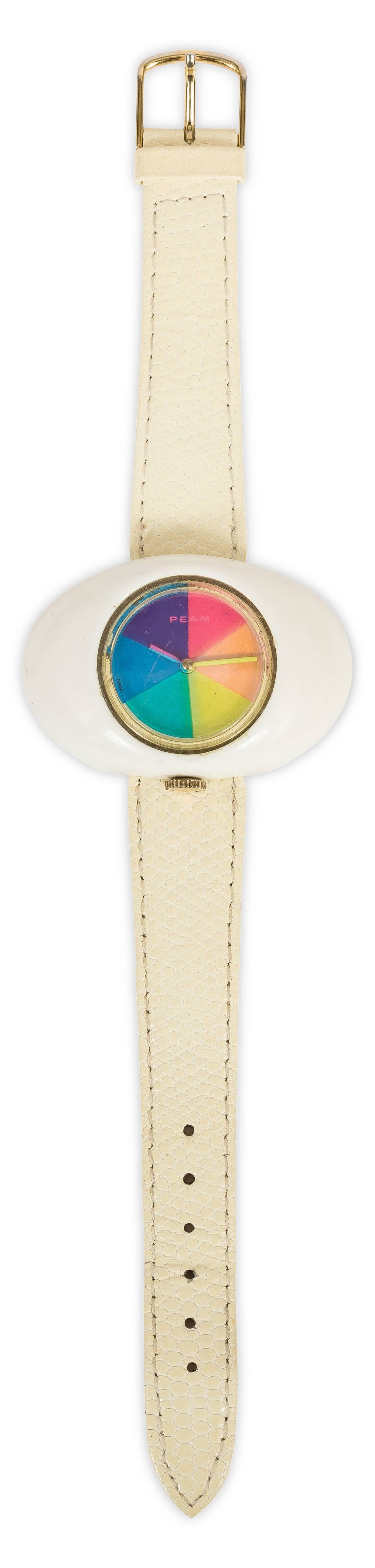 Vintage 1970's French Peam psychedelic oval-shaped watch with rainbow face and dial. Comes with pebbled leather watch band. In working condition - windup dial. In excellent condition with one light, small scratch to watch face.
MEASUREMENTS:
Watch