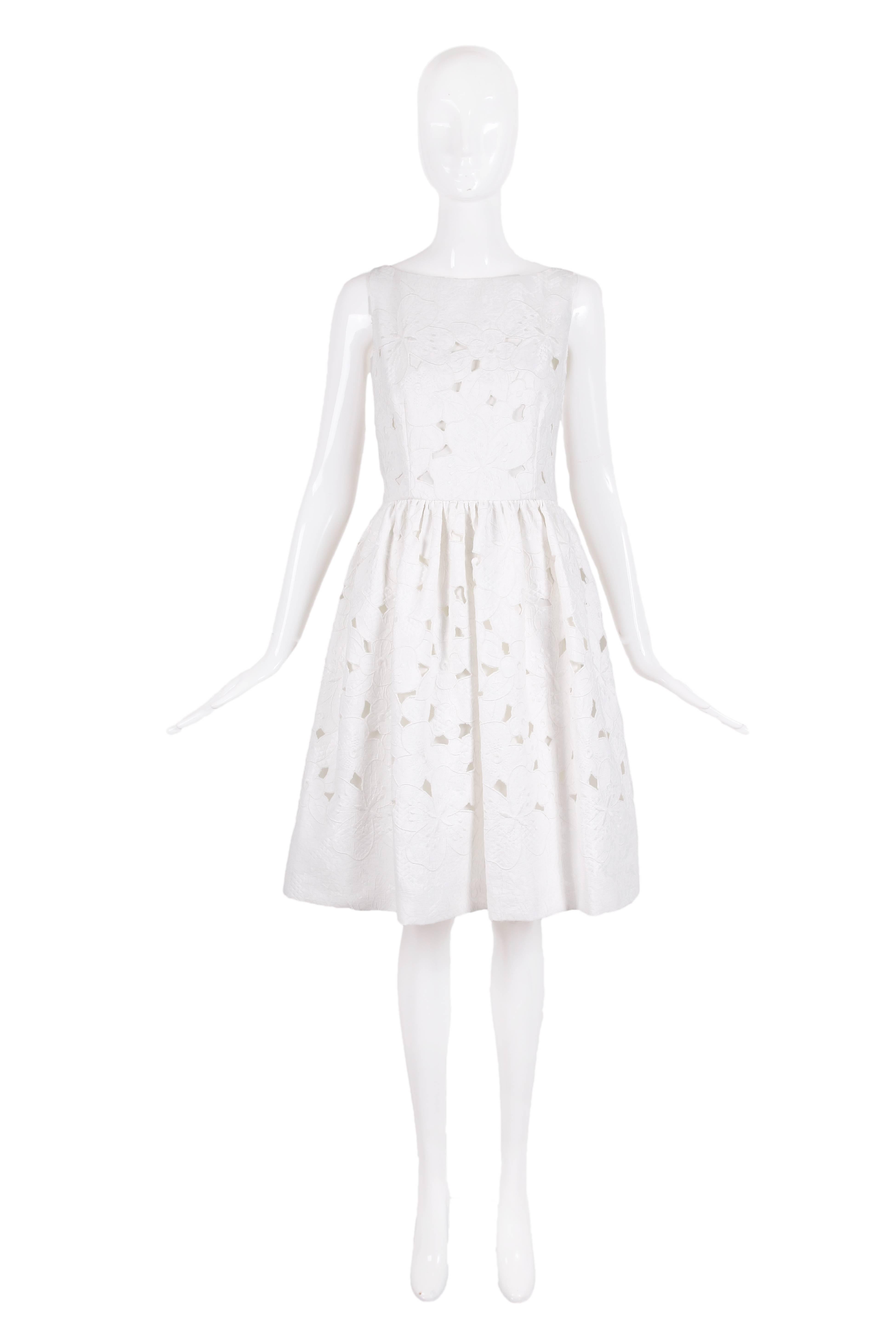 2013 Dolce & Gabbana white cotton sleeveless day dress with floral cutout pattern throughout. Fully lined, size tag 44 - dress has never been worn and still has original tags attached. In excellent condition.
MEASUREMENTS:
Bust - 38"
Waist -
