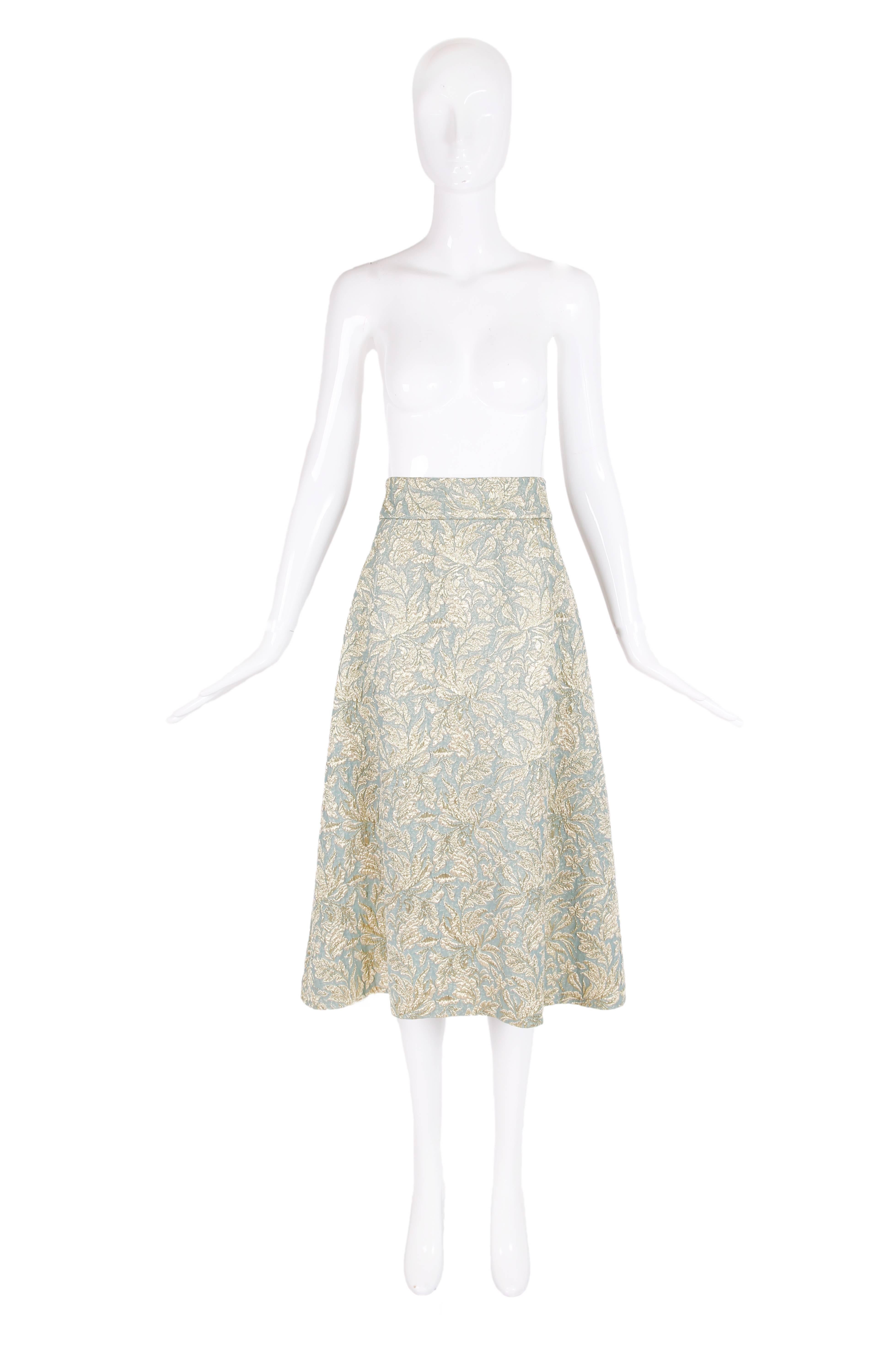 Dolce & Gabbana gold and pale blue metallic foliate pattern flared skirt. In excellent condition - fully lined. Size 46.
Waist - 31"
Length - 31"
