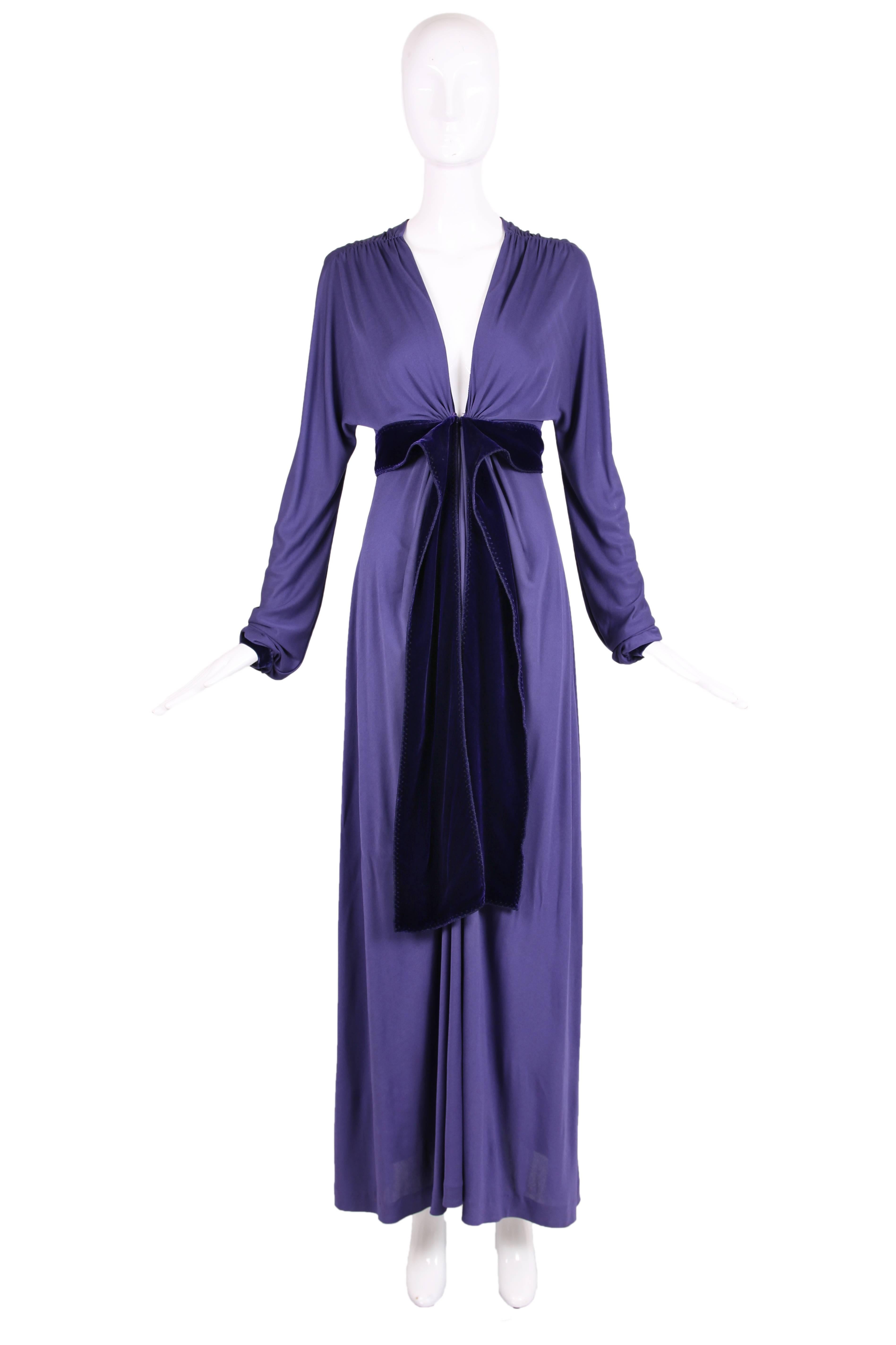 Yves Saint Laurent by Tom Ford purple maxi dress with plunging neckline, empire waist, and extra long sleeves. Ruching at the shoulders and waist with a thick deep purple velvet band to be worn open or tied at front waist. Deep purple velvet trim