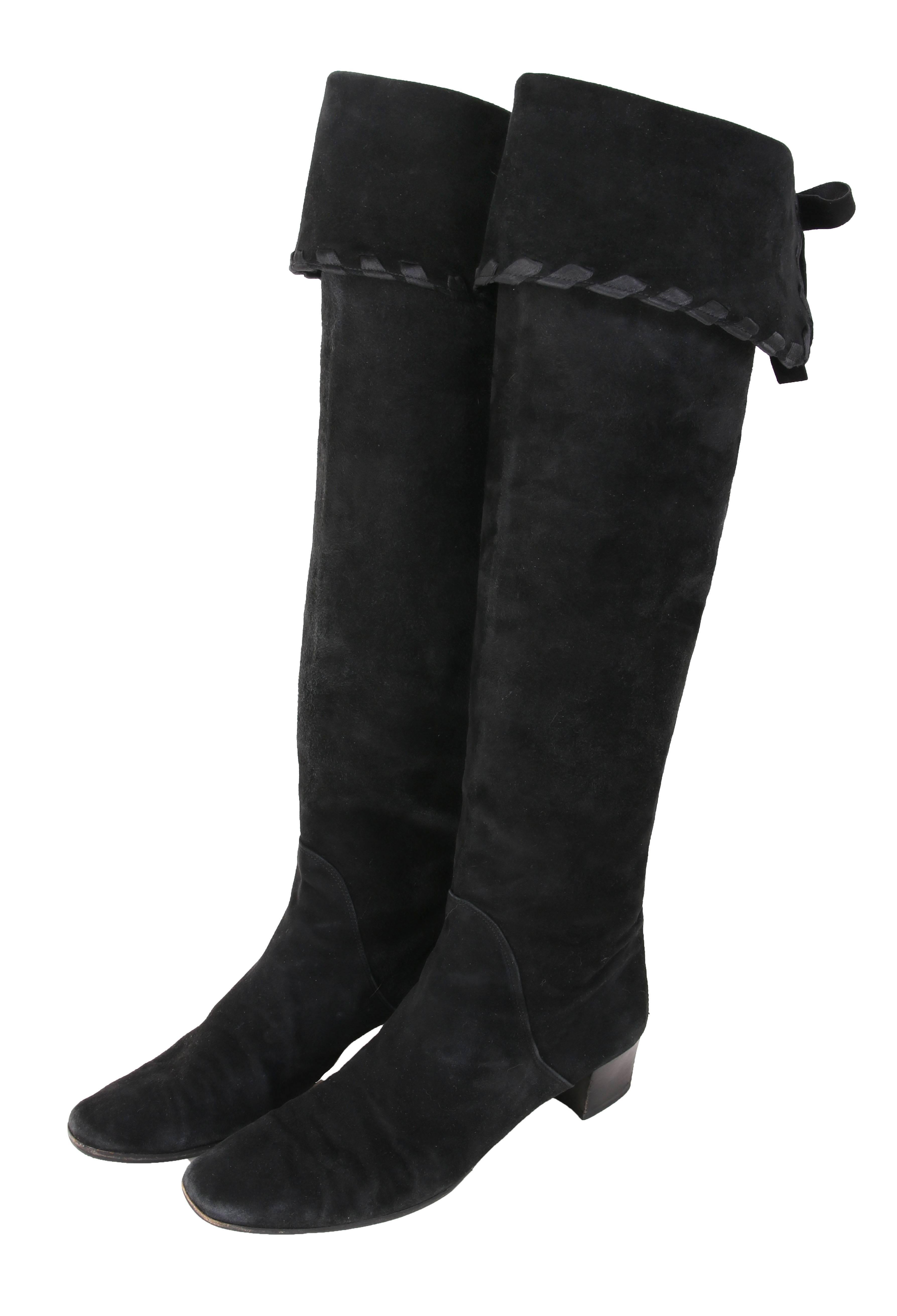 Vintage Yves Saint Laurent YSL black suede boots that can be worn as either knee-high or thigh-high. Top of boot is finished with satin ribbon and decorative leather ties at back. The boots are stamped Yves Saint Laurent at interior at the foot pad