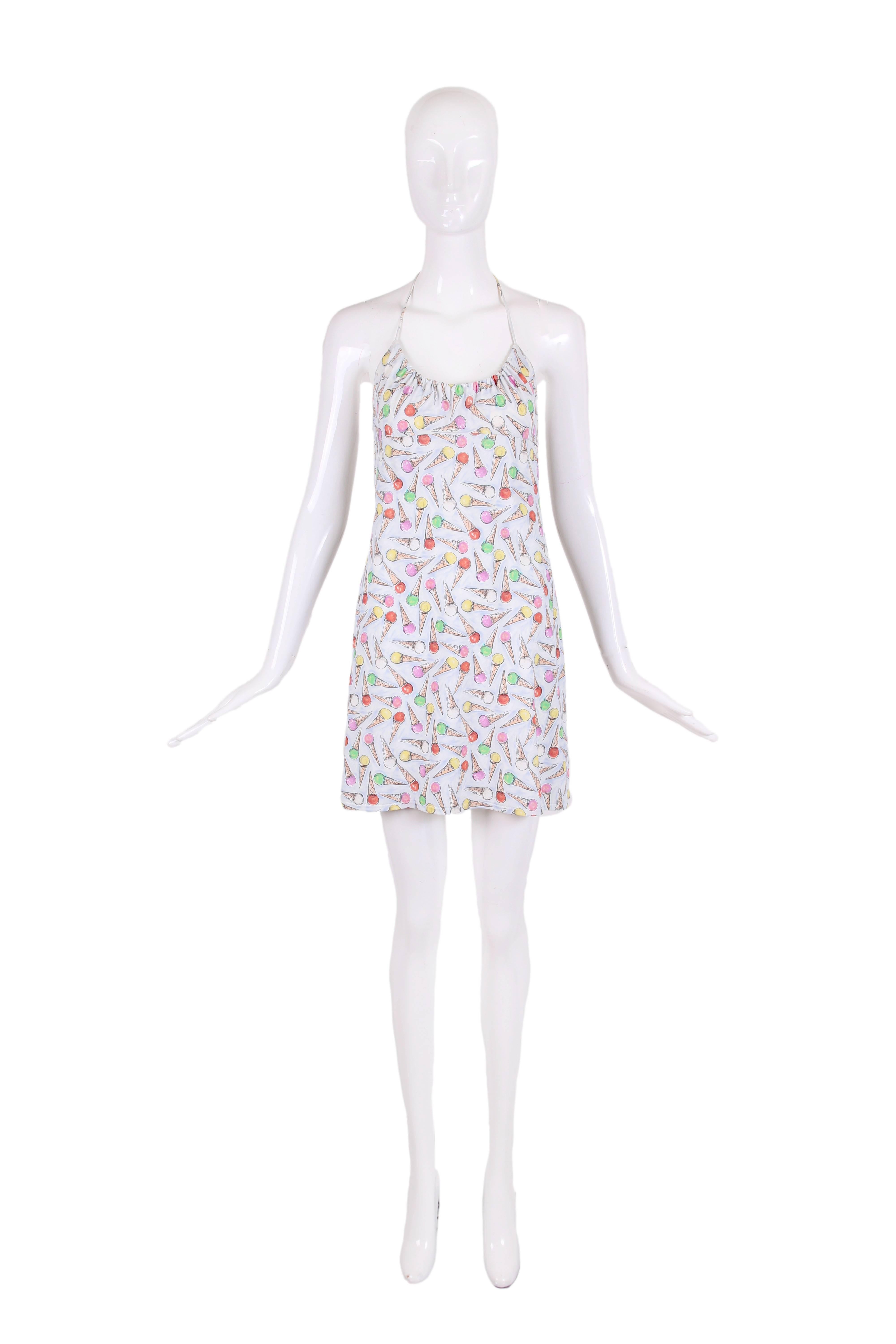 2004C Chanel spandex & nylon blend stretch halter mini dress with a multi-colored ice cream cone print on a light blue background. Neckline is gathered and can be made smaller or larger and has ties with a green and pink plastic CC logo ball at each