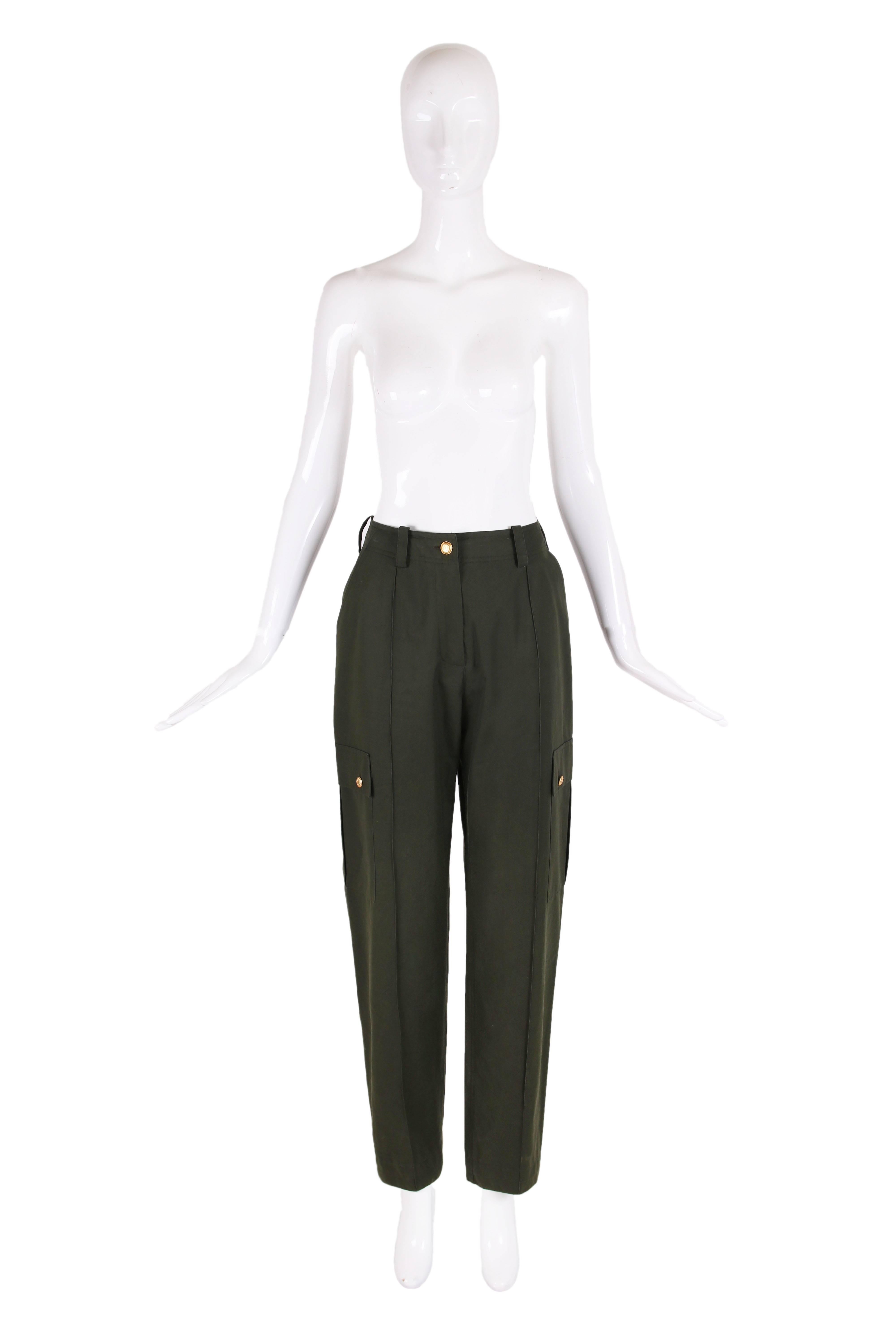 Vintage Chanel olive green high-waisted cotton cargo pants featuring belt loops,  two side pockets, and two cargo pockets with two gold-toned CC logo buttons on each cargo pocket. In excellent condition. Size EU 40. 
Waist - 28"
Hip -
