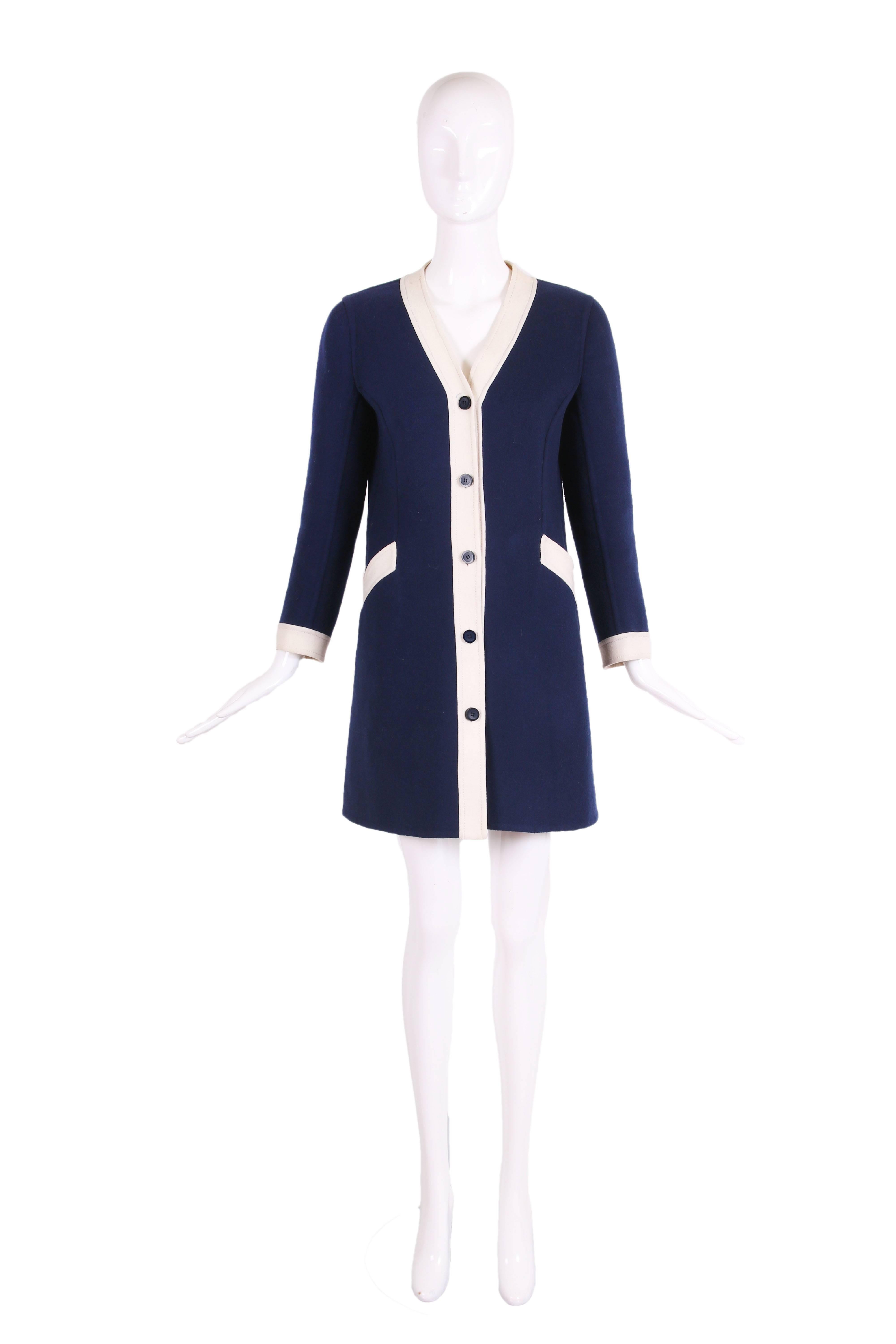 1970's Valentino navy melton wool coat dress featuring white trim, navy buttons down center front, and two frontal pockets. In excellent condition with a few unnoticeable marks at right shoulder and light blue mark near top button - it has not been