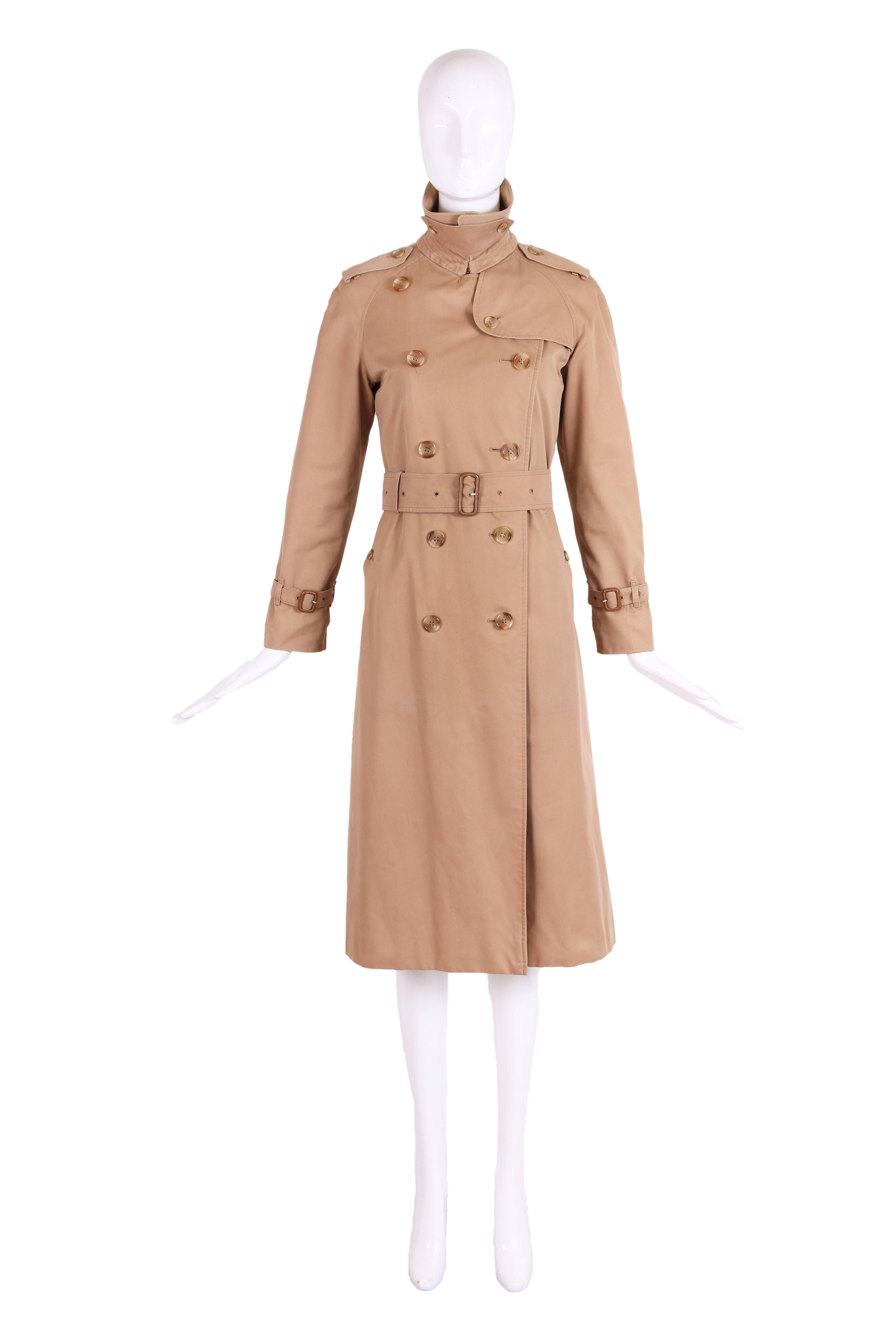 Classic vintage Burberry belted trench coat in camel and belt with leather covered buckle. Interior lining in plaid cotton with a detachable zippered plaid wool lining layered on top of that. In excellent condition. No size tag - this will most