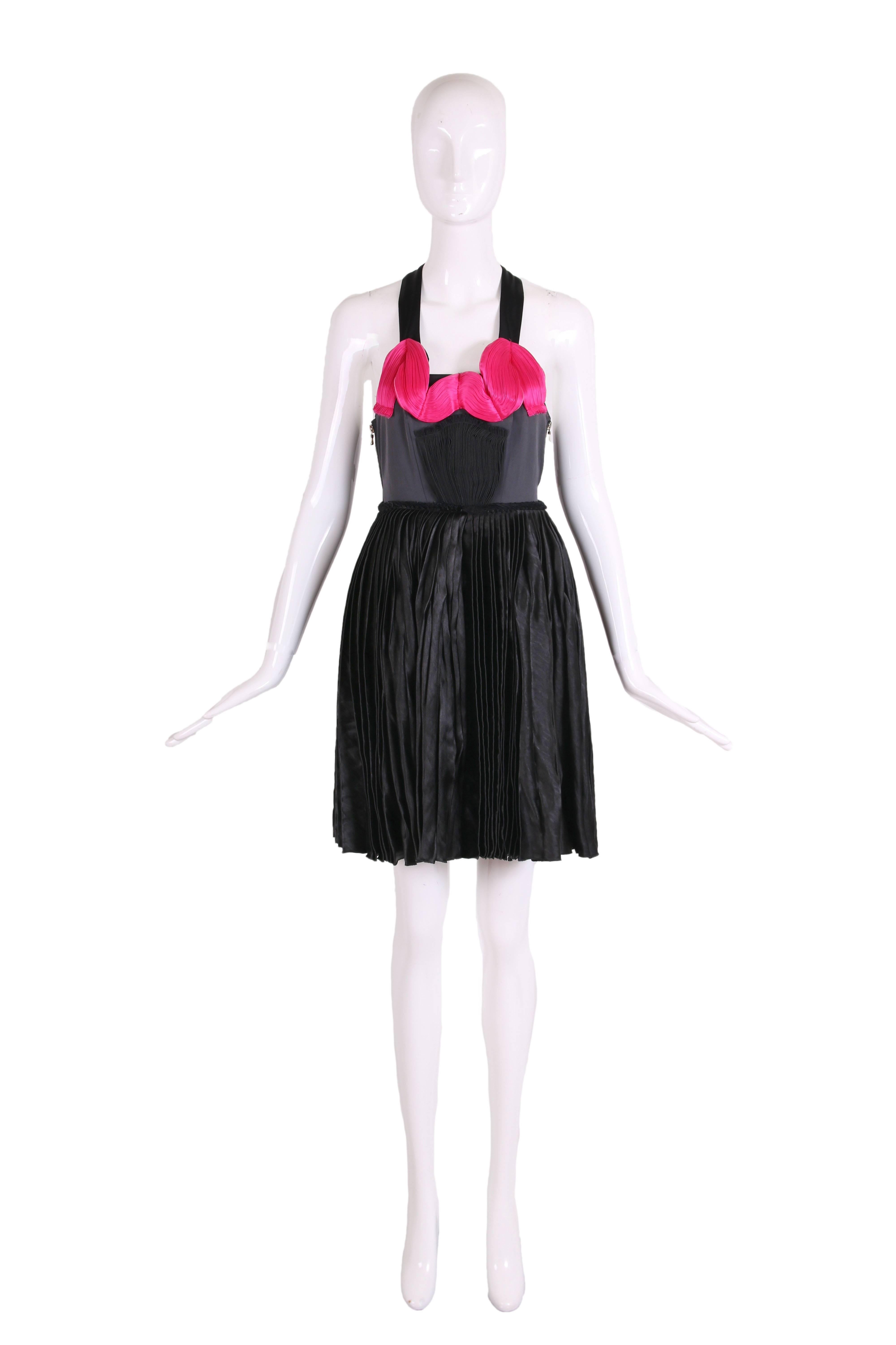 2007 Lanvin black silk, viscose and paper blend mini dress with pleating at the waistline and skirt, straps and hot pink silk pleated design detail at bust. Has two side zippers - one is a closure and the other is decorative. Size tag 36 - please