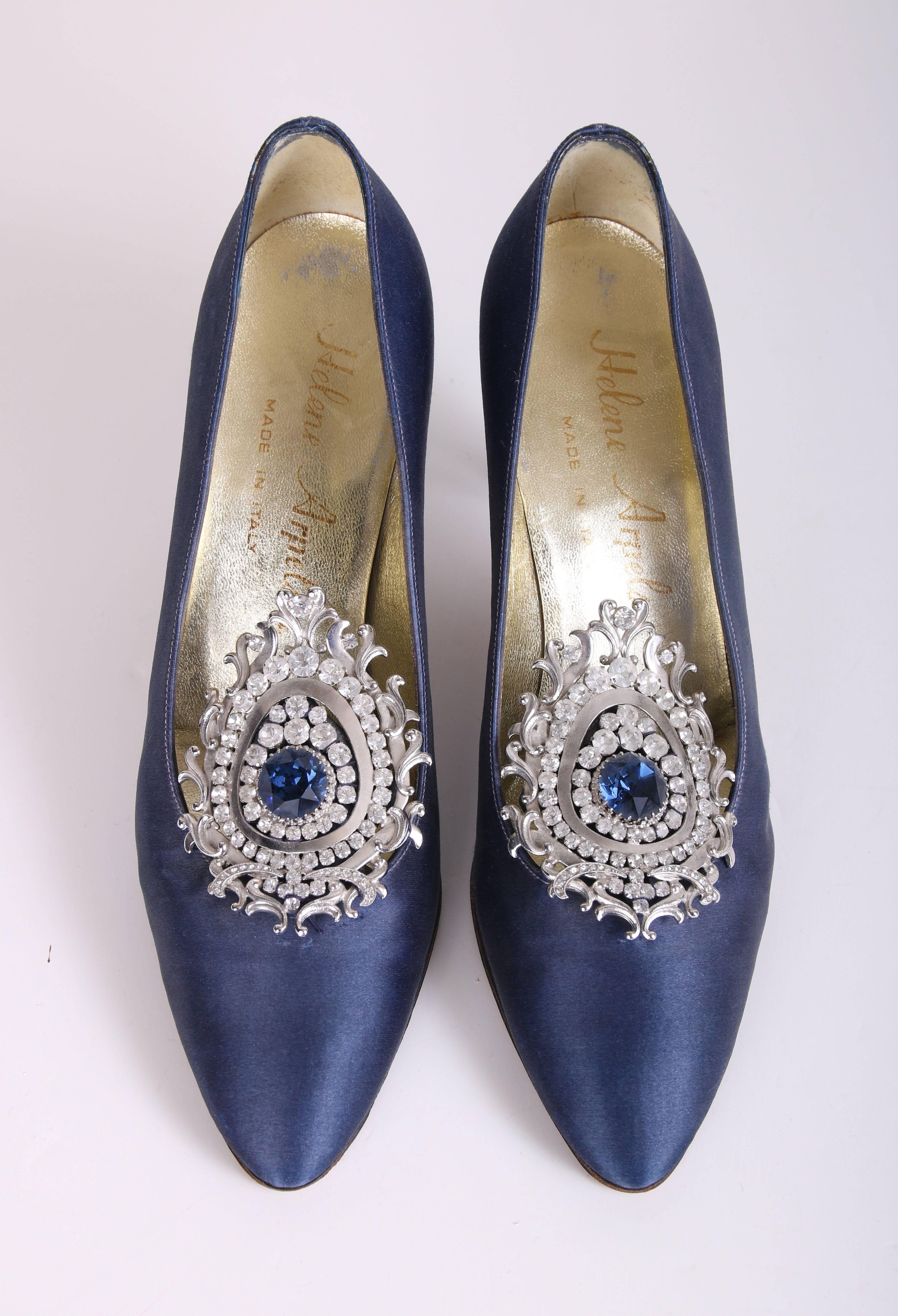 Vintage Helene Arpels blue silk pumps with jeweled design at vamp. Helene Arpels logo at inner bottom. In excellent condition with some light wear at bottom of shoes. Size 7AA. 
