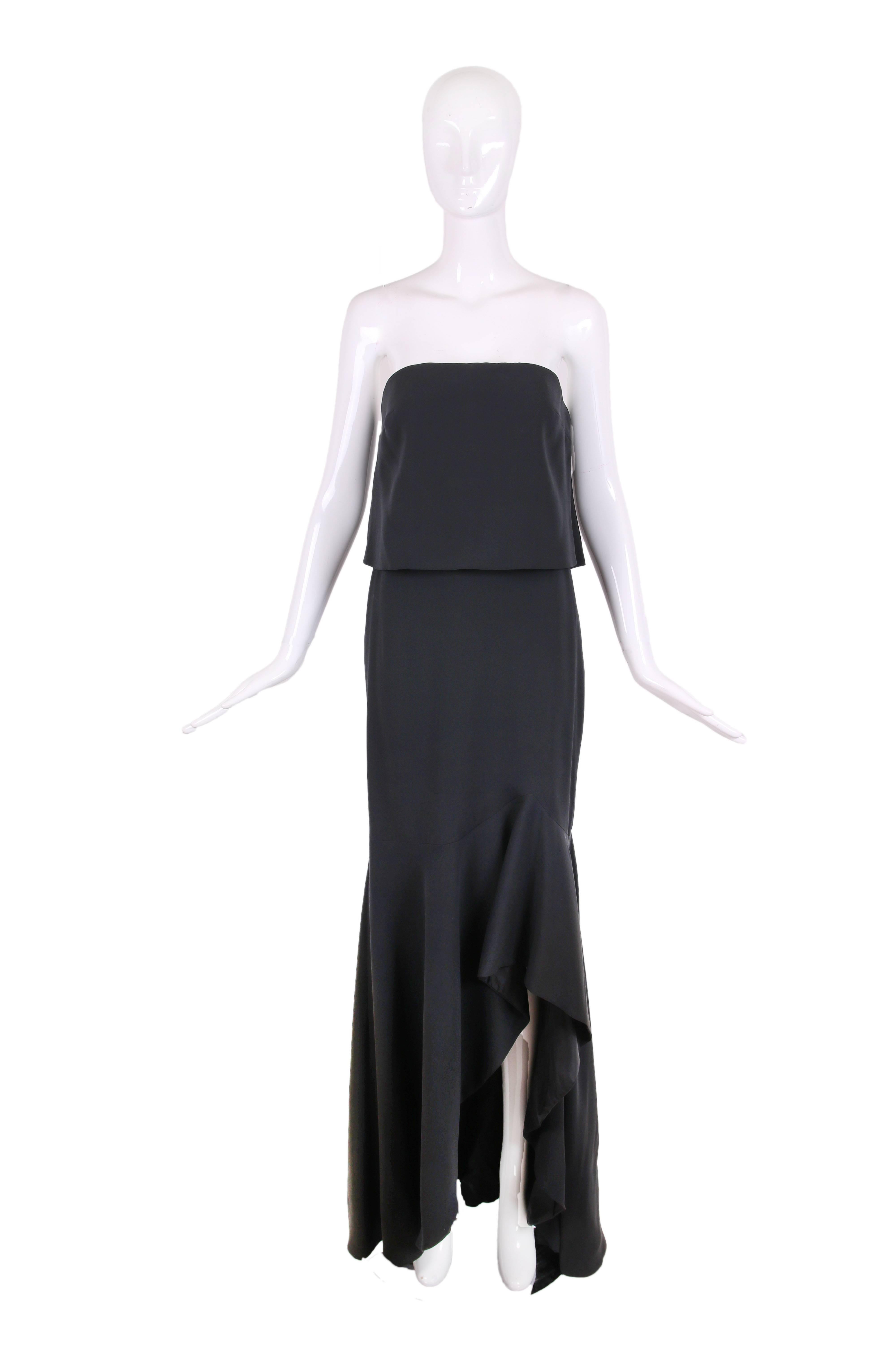 Tom Ford black silk blend strapless gown with a piece of fabric laying on top of a hidden bustier at the bodice with interior boning, a dramatic and slightly ruffled frontal slit and matching bolero top. Size 38, in excellent condition. Please see