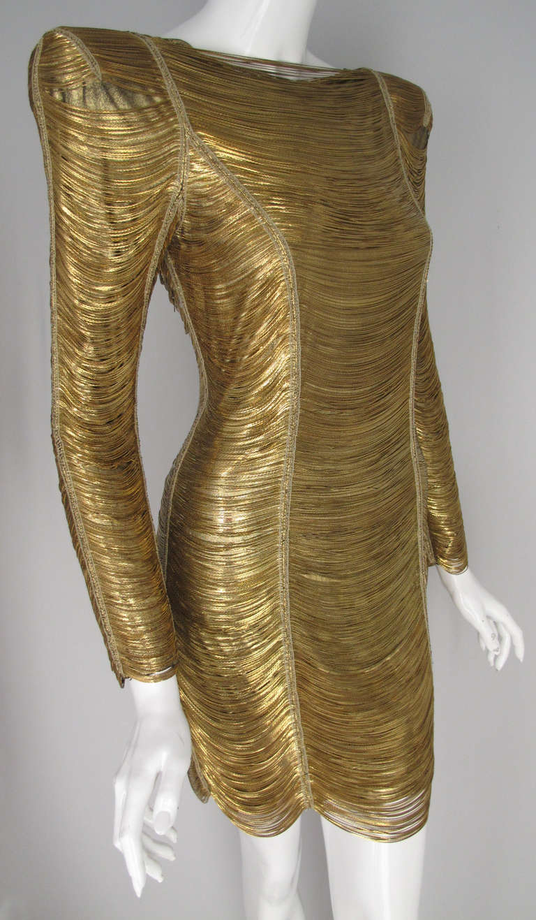 An Insanely gorgeous Balmain mini dress fabricated entirely of gold chain with a  supple lambskin leather under layer that was embroidered by hand. A signature and iconic look from Balmain of the Christophe Decarnin era - sleek, edgy and entirely