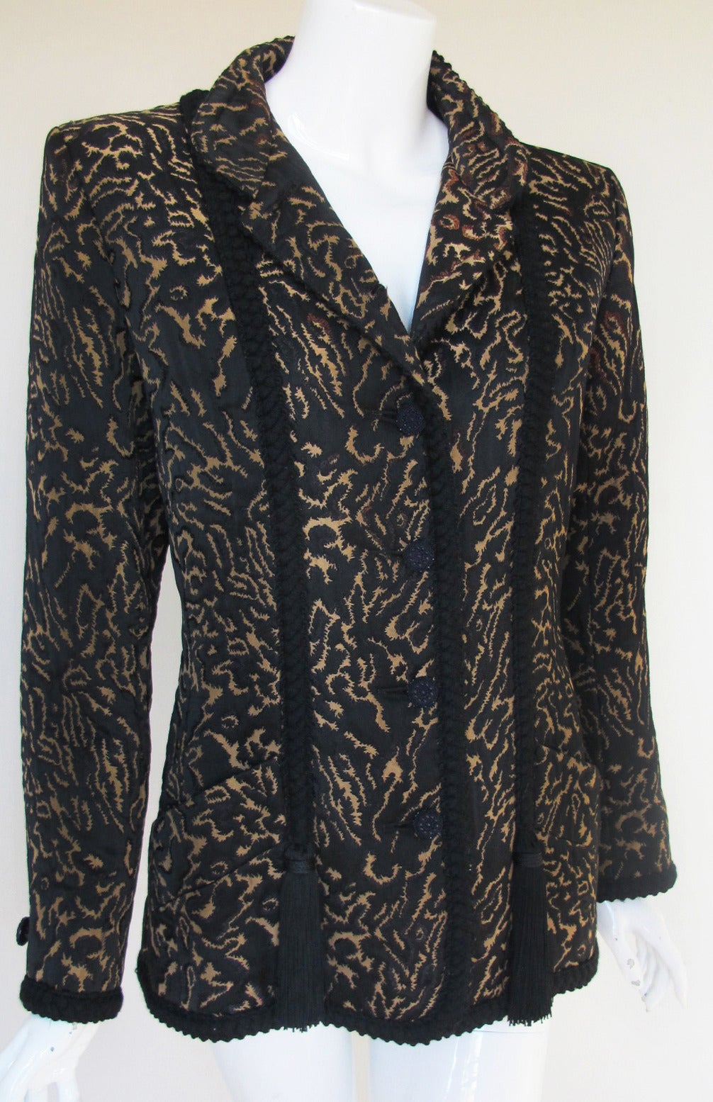 A vintage Yves Saint Laurent Rive Gauche silk satin brocaded evening jacket in an abstract feline skin pattern in shades of black, golden brown and light olive/taupe. Features a Mandarin collar that can be worn up or down, angled hem pockets, black