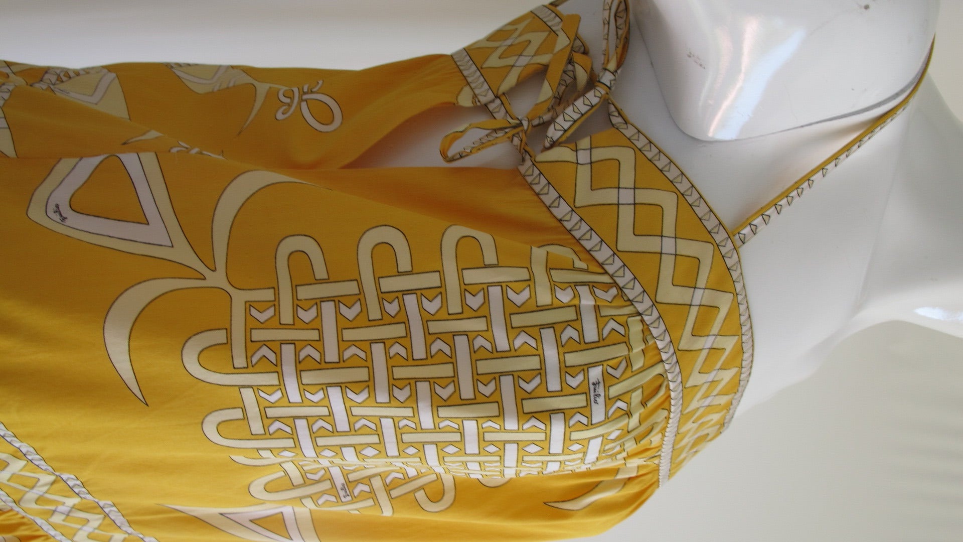 A vintage 1970s Emilio Pucci geometric print cotton sundress in shades of marigold, pale yellow and white with sides ties at the bodice top, a slightly dropped waist and double-tiered skirt. In excellent condition. Size 6.
MEASUREMENTS:
Bust -