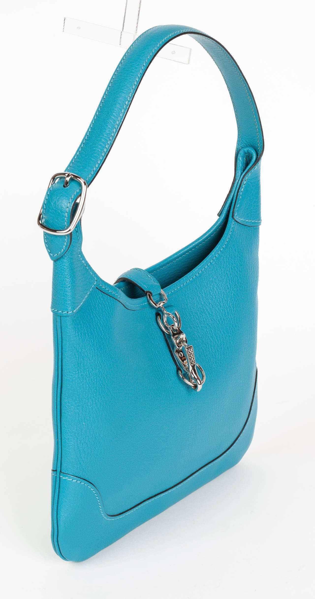 2004 Hermes Turquoise Chevre Mystore leather 24cm mini trim bag with palladium hardware. Features one non-adjustable shoulder strap and an interior slip pocket. Stamped Hermes with blind stamp on underside of shoulder strap at buckle. In excellent