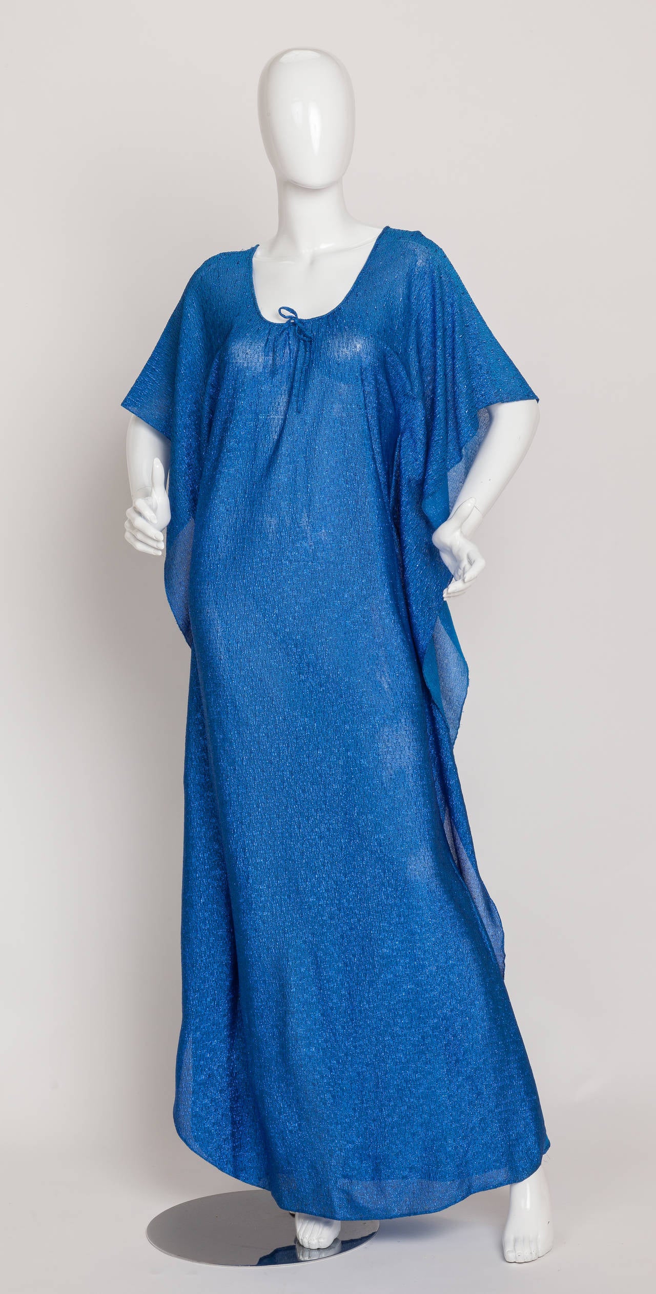 A 1980s Pierre Cardin metallic blue caftan or djellaba with flutter sleeves and decorative ties at the neckline. I'm such a fan of the simplicity of this beautiful and slightly sheer garment which is constructed out of two pieces of fabric joined by