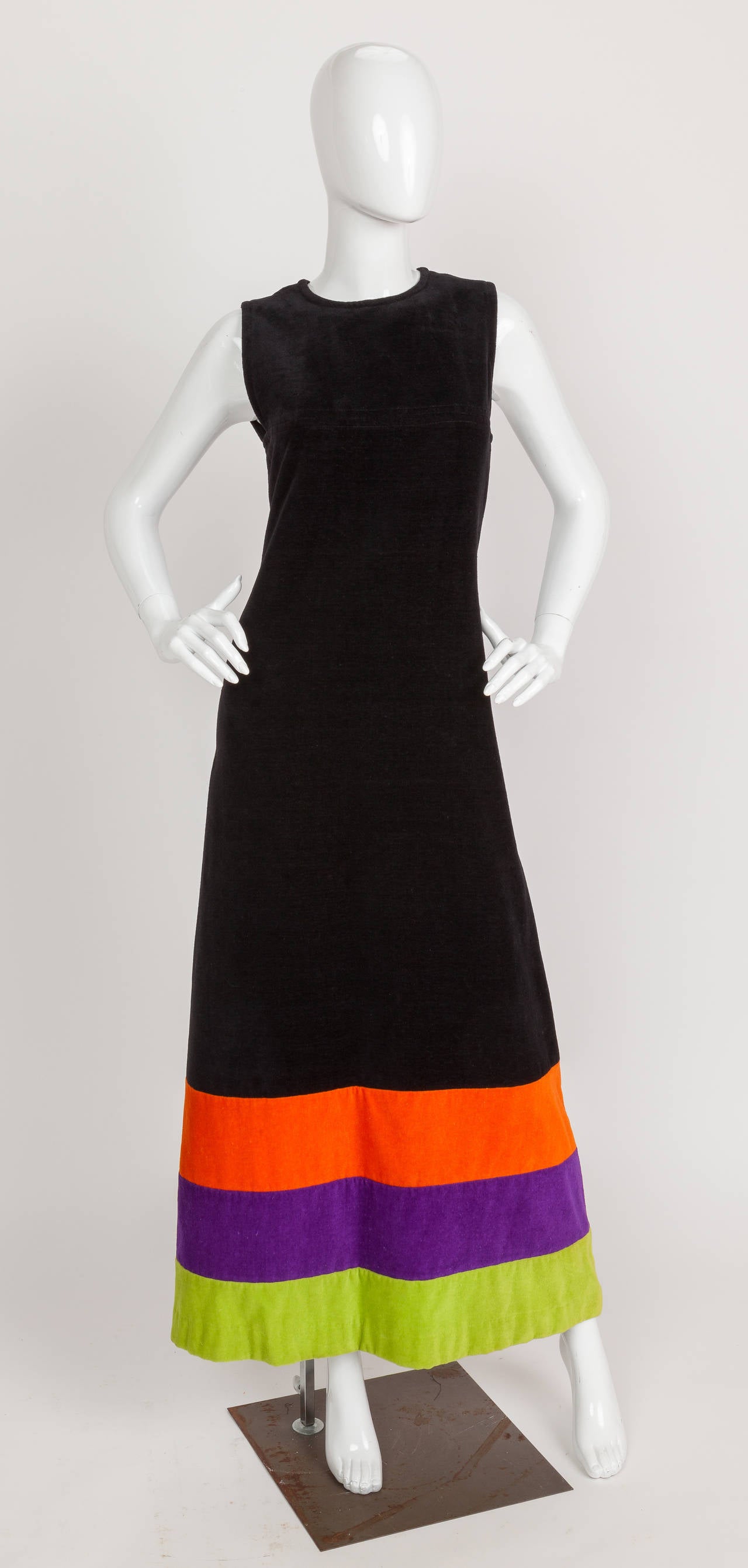 This 1970s Pierre Cardin terry cloth maxi dress with fitted bodice, A-line silhouette and bright orange, acid green and purple bands at the hem. Zips up the center back. In excellent condition. Size tag 38. Labeled: Pierre Cardin Creation