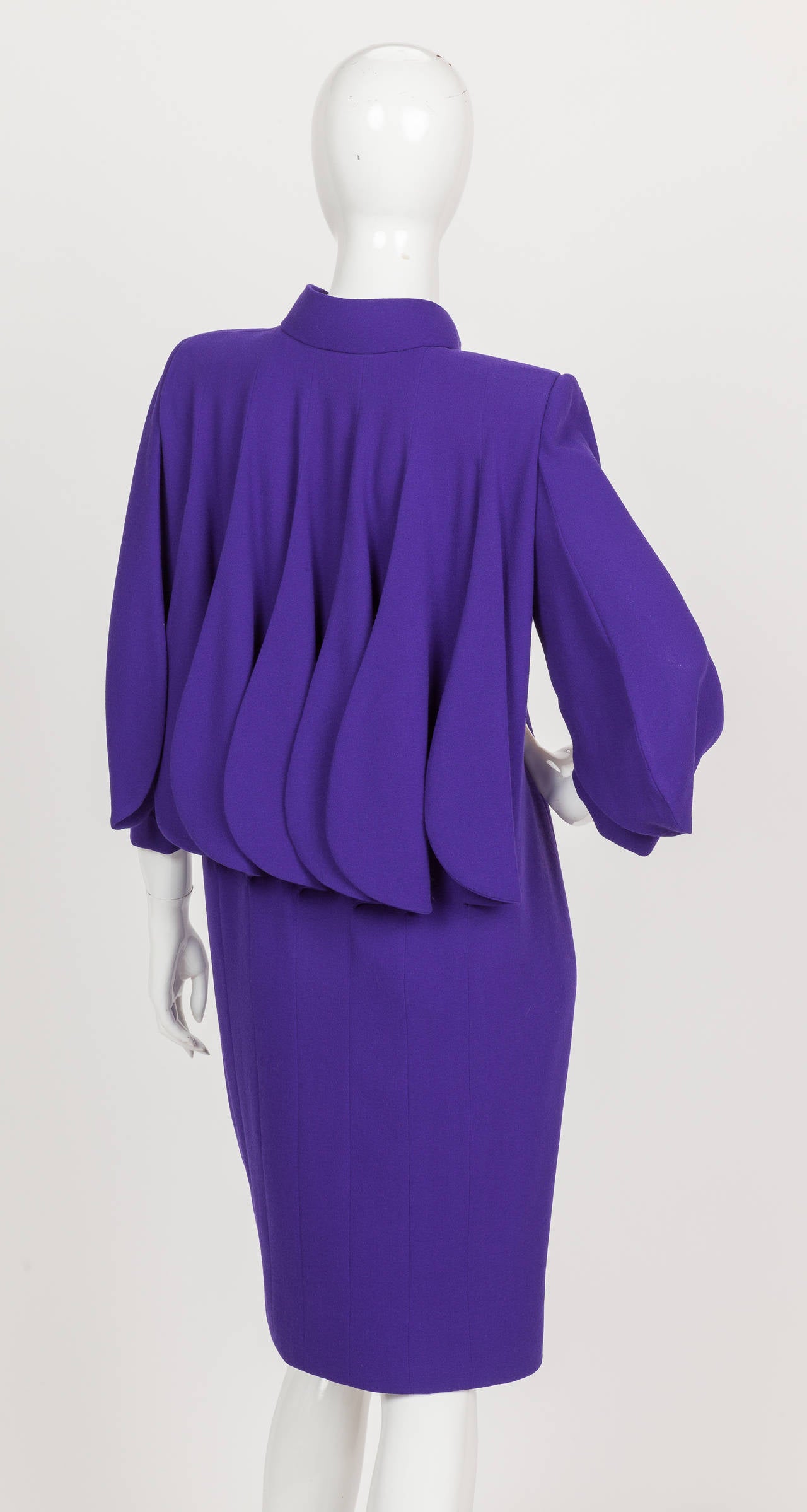 A circa 1992 Pierre Cardin haute couture  purple wool crepe cocktail dress with 3/4 sleeves that features a signature Cardin design motif - 