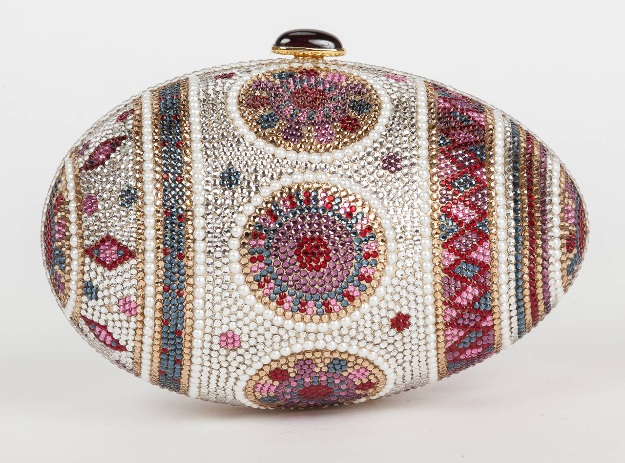 The highly collectible, circa 1983 Judith Leiber 'Faberge Egg' inspired minaudière encrusted with multi-colored Swarovski crystals and trademark mirror. Each Judith Leiber minaudière is hand-crafted and requires several days to complete. A model is