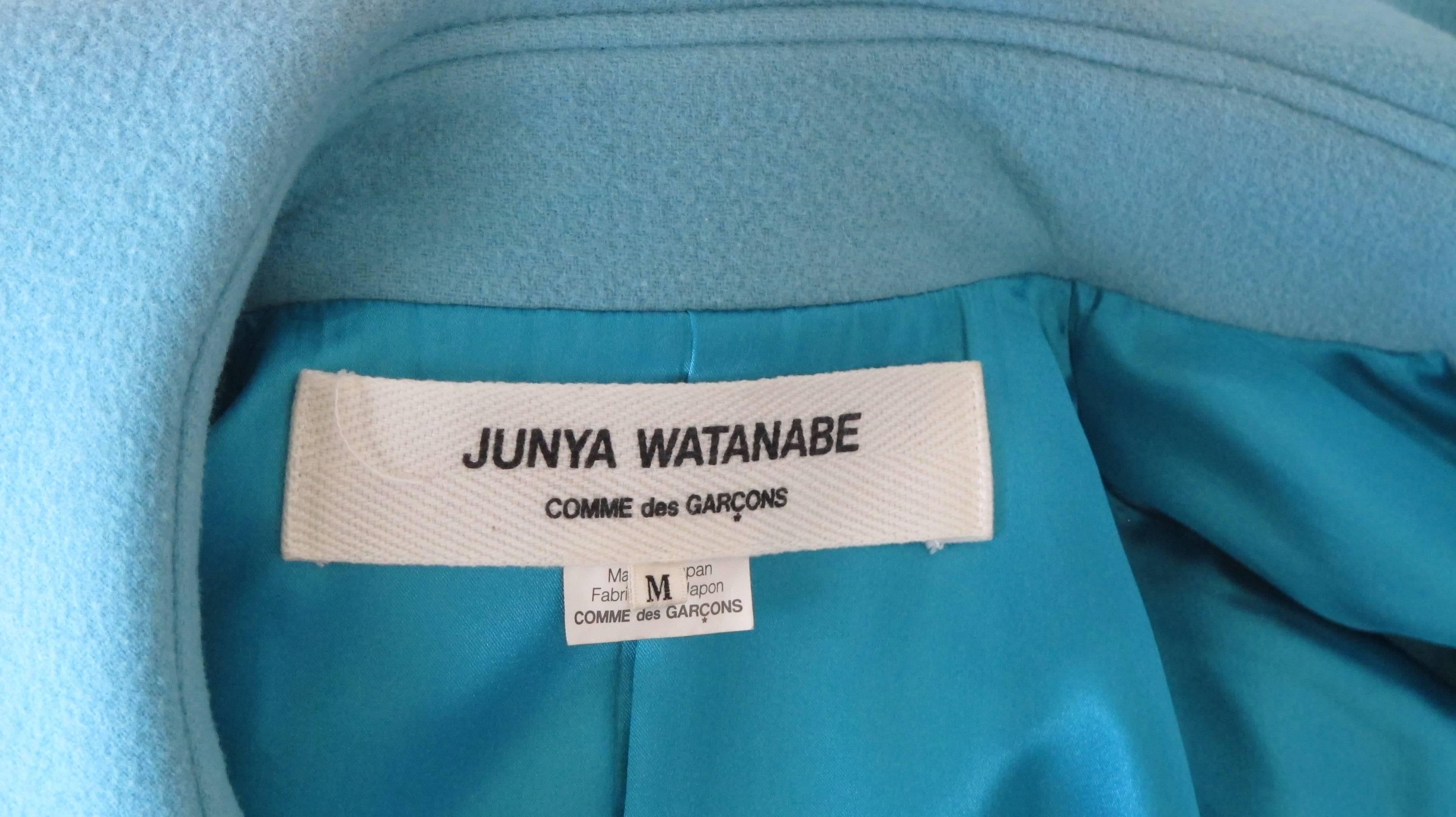A 2001 powder blue Junya Watanabe for Comme des Garcons melton wool swing coat with oversized Peter Pan collar and oversized white button closures down the front. Fully lined. Size M. In very good condition with some very hard to see color fading of