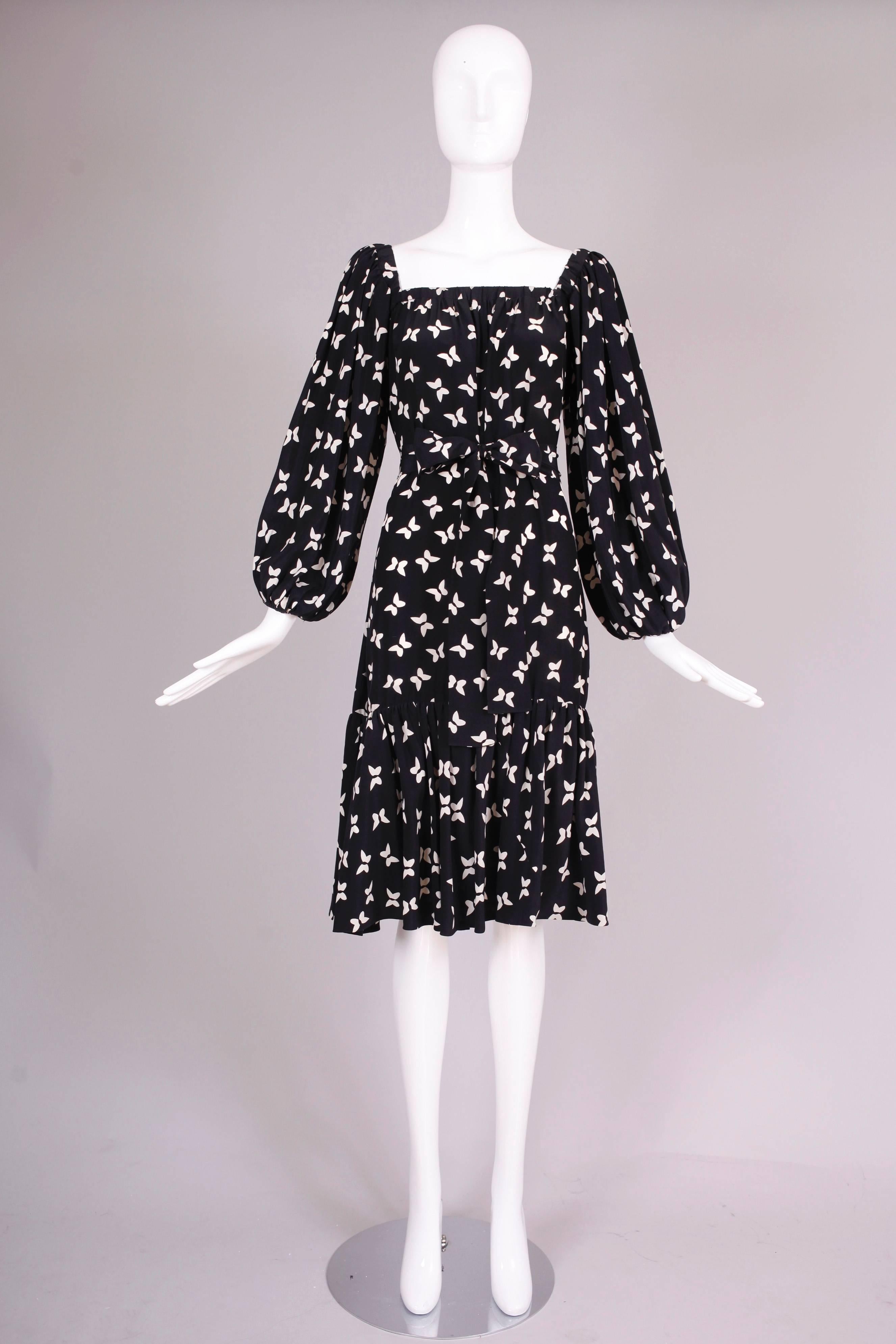 A 1970's Yves Saint Laurent black silk day dress with white butterfly print, elasticized square neck, balloon sleeves, a 2.5