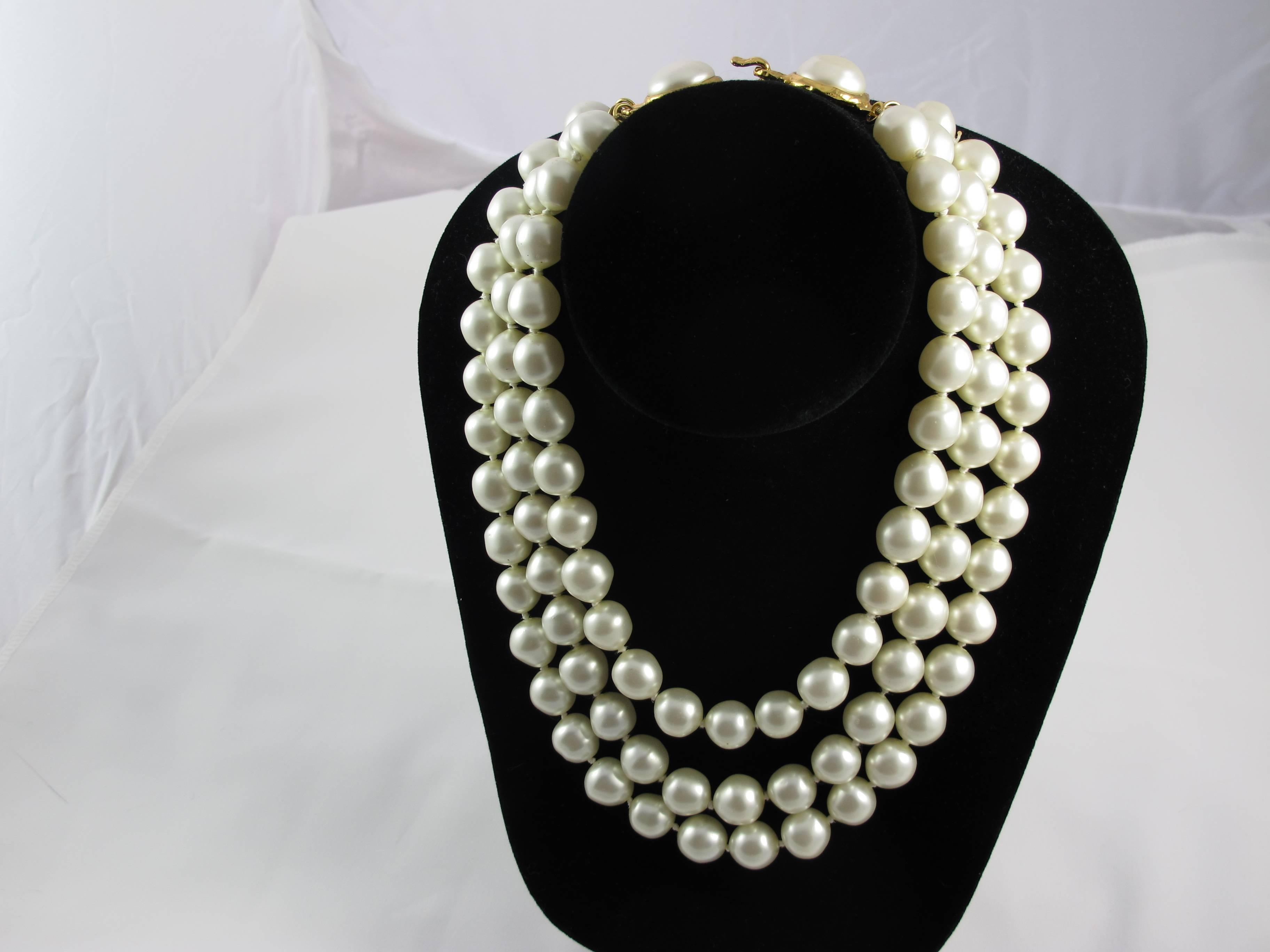 A 1970's Chanel triple strand faux pearl choker with a gold tone 