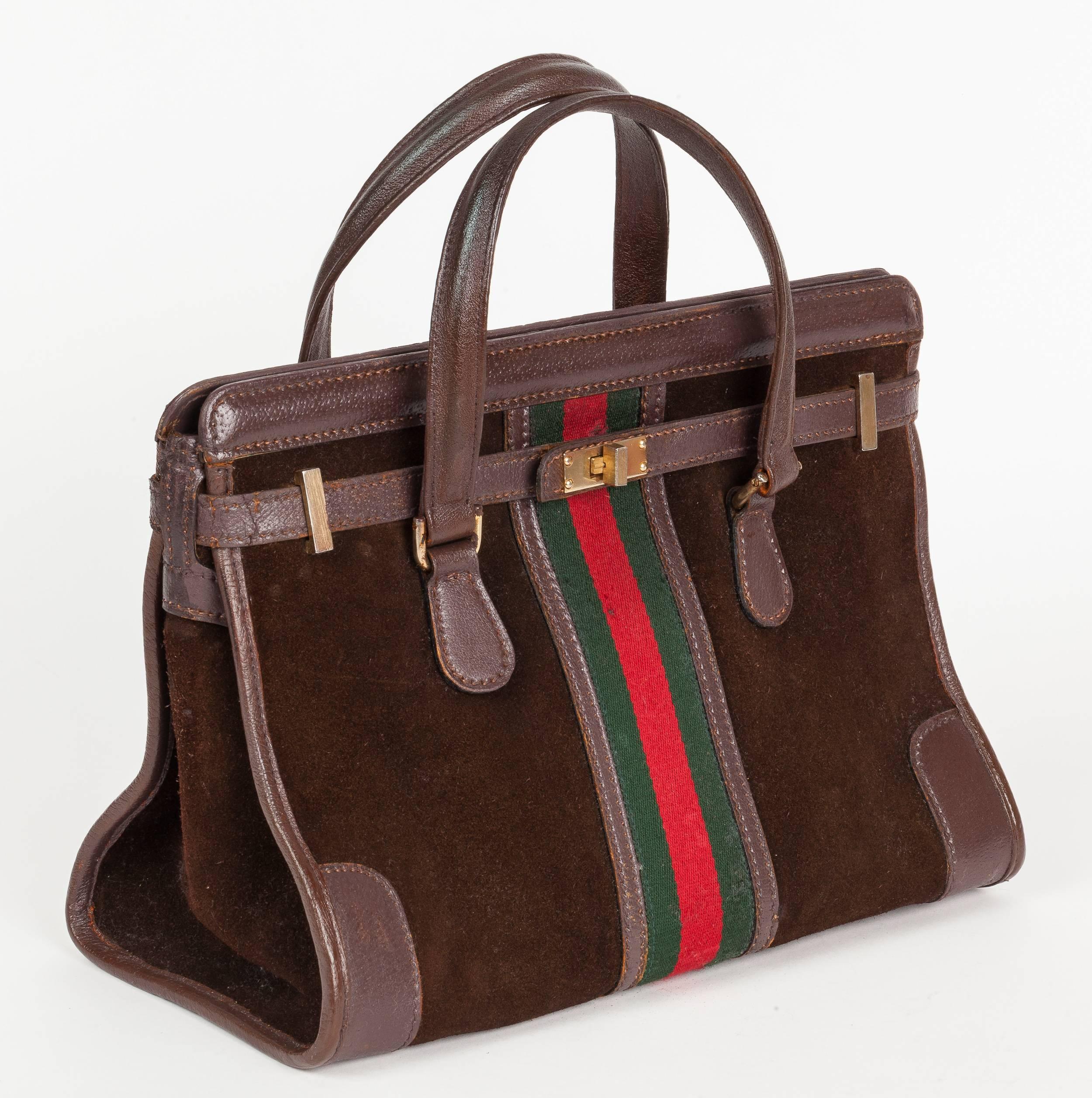 A rare 1970s Gucci brown suede open-top doctor's bag or tote with brown leather trim, gold hardware and iconic Gucci green and red canvas racer stripe detail at center back and front. Features a wraparound brown leather strap, brass turnlock closure