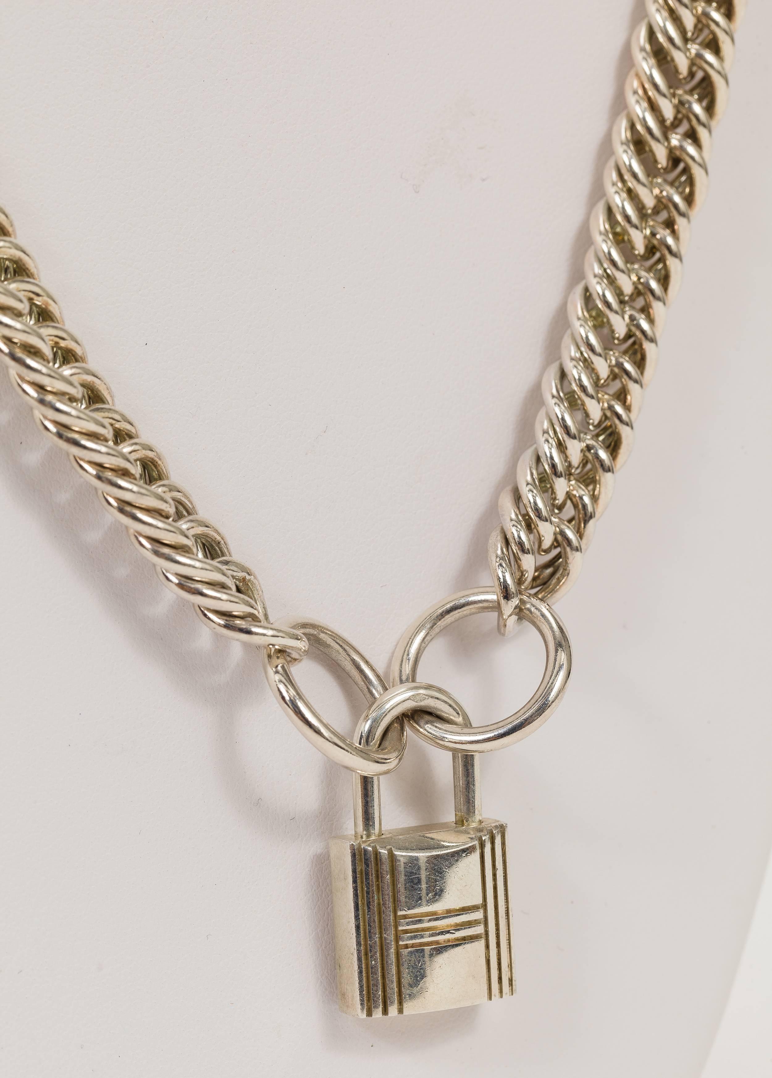 Modern Hermes heavy sterling silver open curb link necklace with an attached sterling silver Hermes lock charm. Weight of the sterling silver 6.395 troy ounce. Stamped 