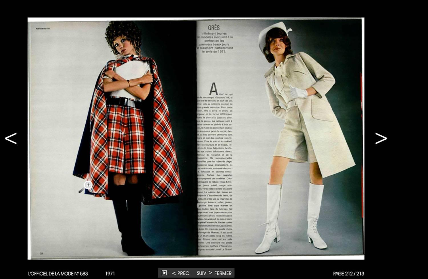 As shown in a 1971 spread from L'Official magazine is this gorgeous Madame Gres haute couture navy blue wool cape with red, navy and white plaid interior. Opens at center front and fastens by means of two oversize blue buttons at the top. There are