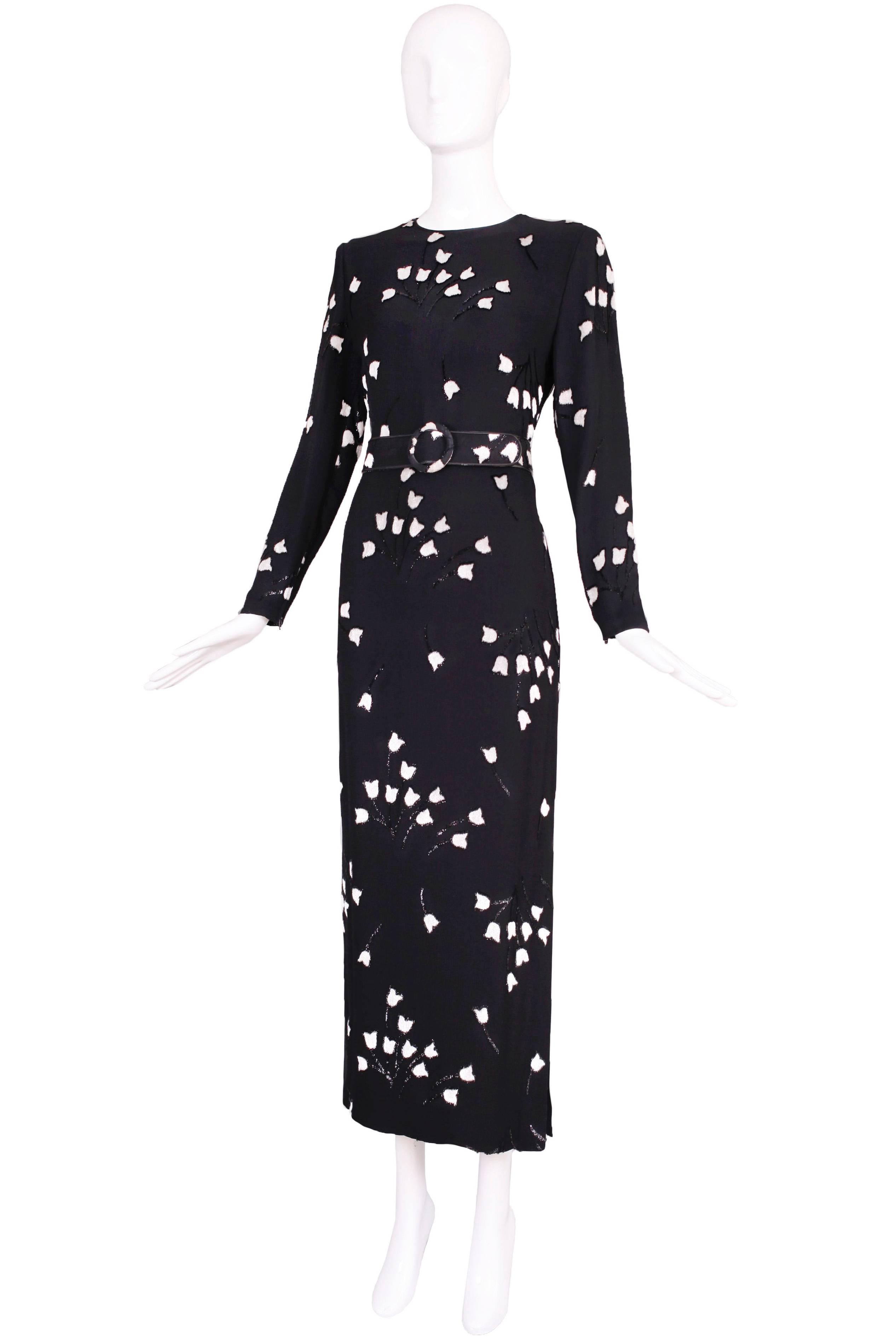 Galanos silk black velvet burnout long sleeved evening gown with white/gray tulip pattern. Features a side slit and zippers at the sleeves. The label was removed from the dress but the belt is stamped: Galanos. There is no size tag so please consult