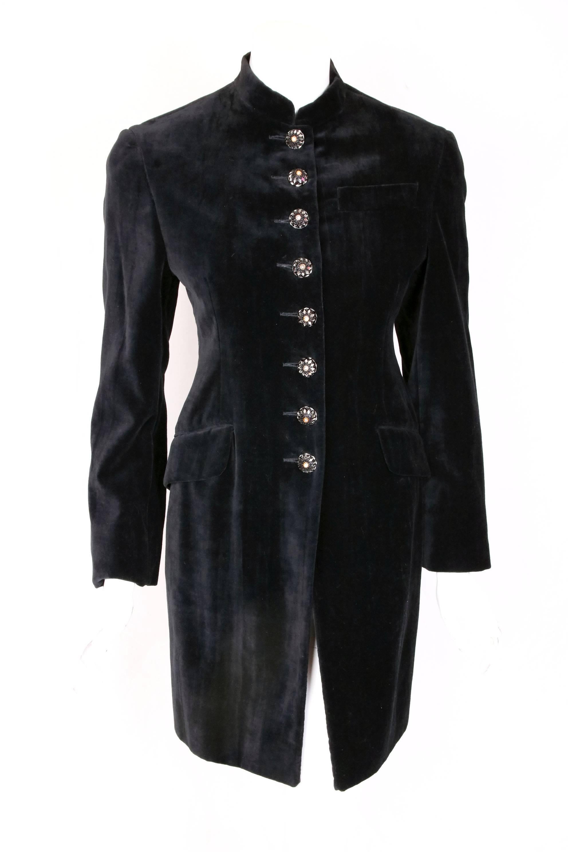 A circa 1989 Romeo Gigli black velvet fitted coat with nehru collar, oversized dome-shaped mirrored buttons, three frontal pockets and kick pleat at the back.  Fully lined. In excellent condition. Size tag 40. Please consult