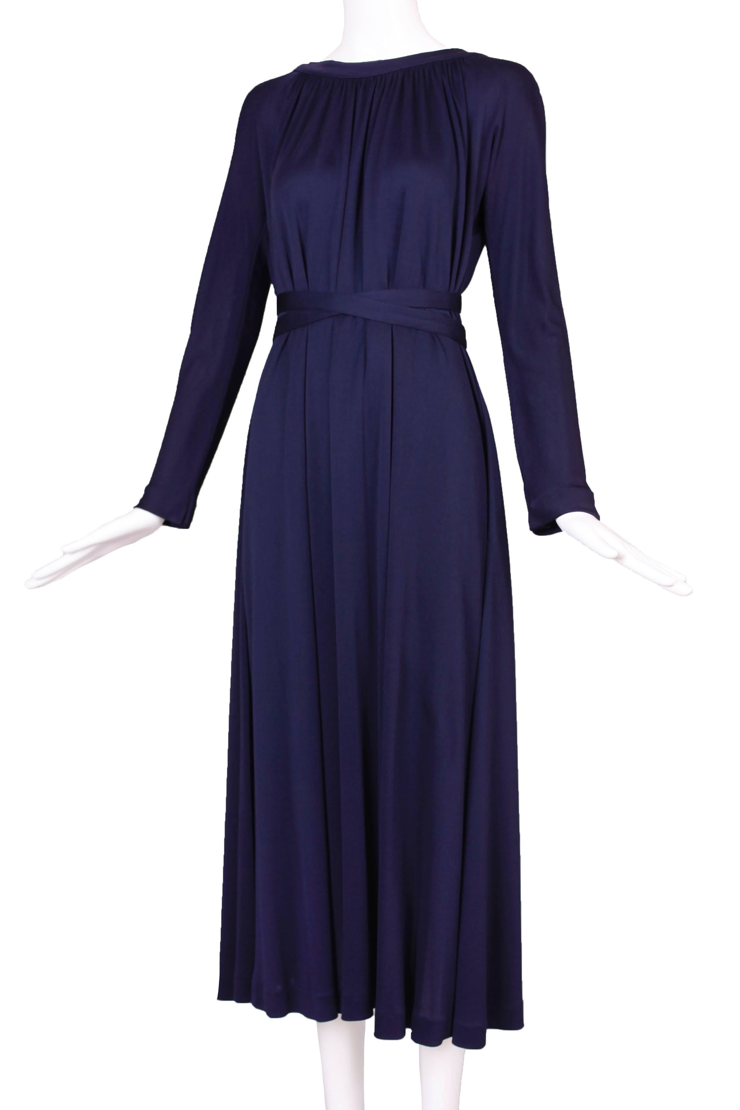 1970’s Geoffrey Beene for Saks Fifth Avenue midnight blue silk jersey dress with a gathered neckline and two long ties attached at the back that wrap around as a belt and two hidden side pockets. In very good to excellent condition with a small