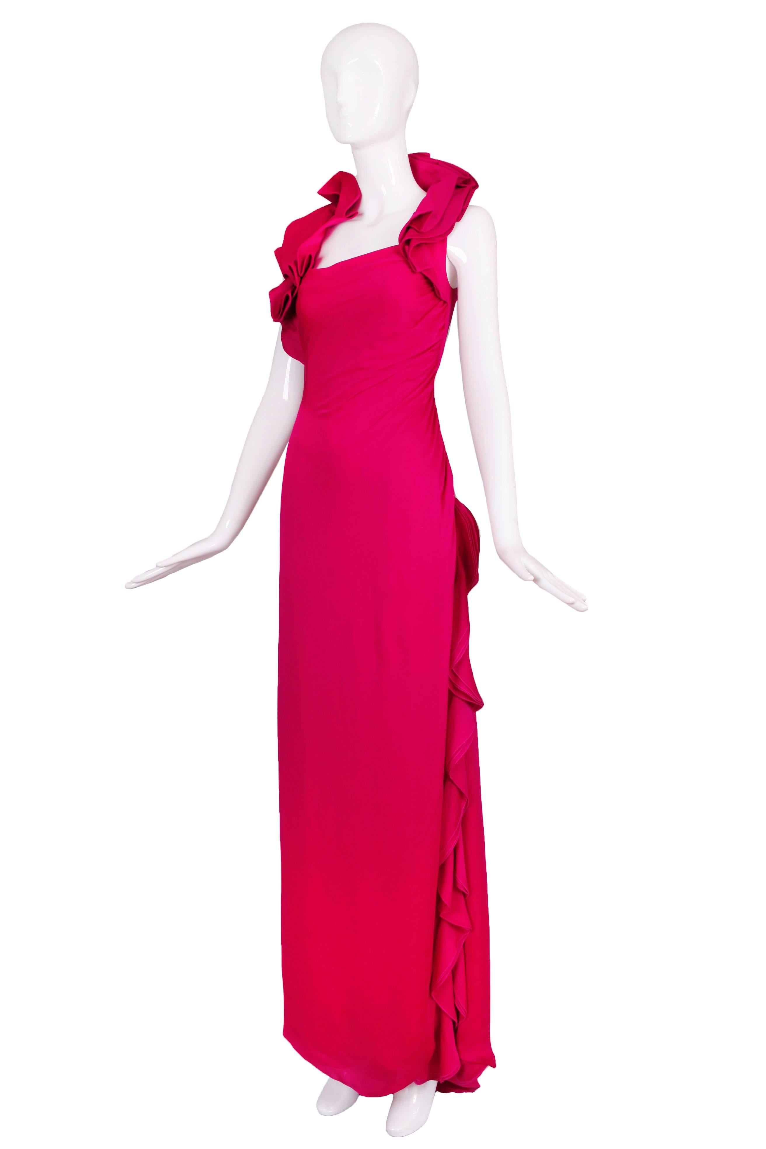 A contemporary Valentino triple-layered silk fuchsia evening gown with asymmetric ruffled collar and slight train at the back. Cut on the bias, the fabric is gathered at the upper left side and layered side ruffles that begin at the hip and turn