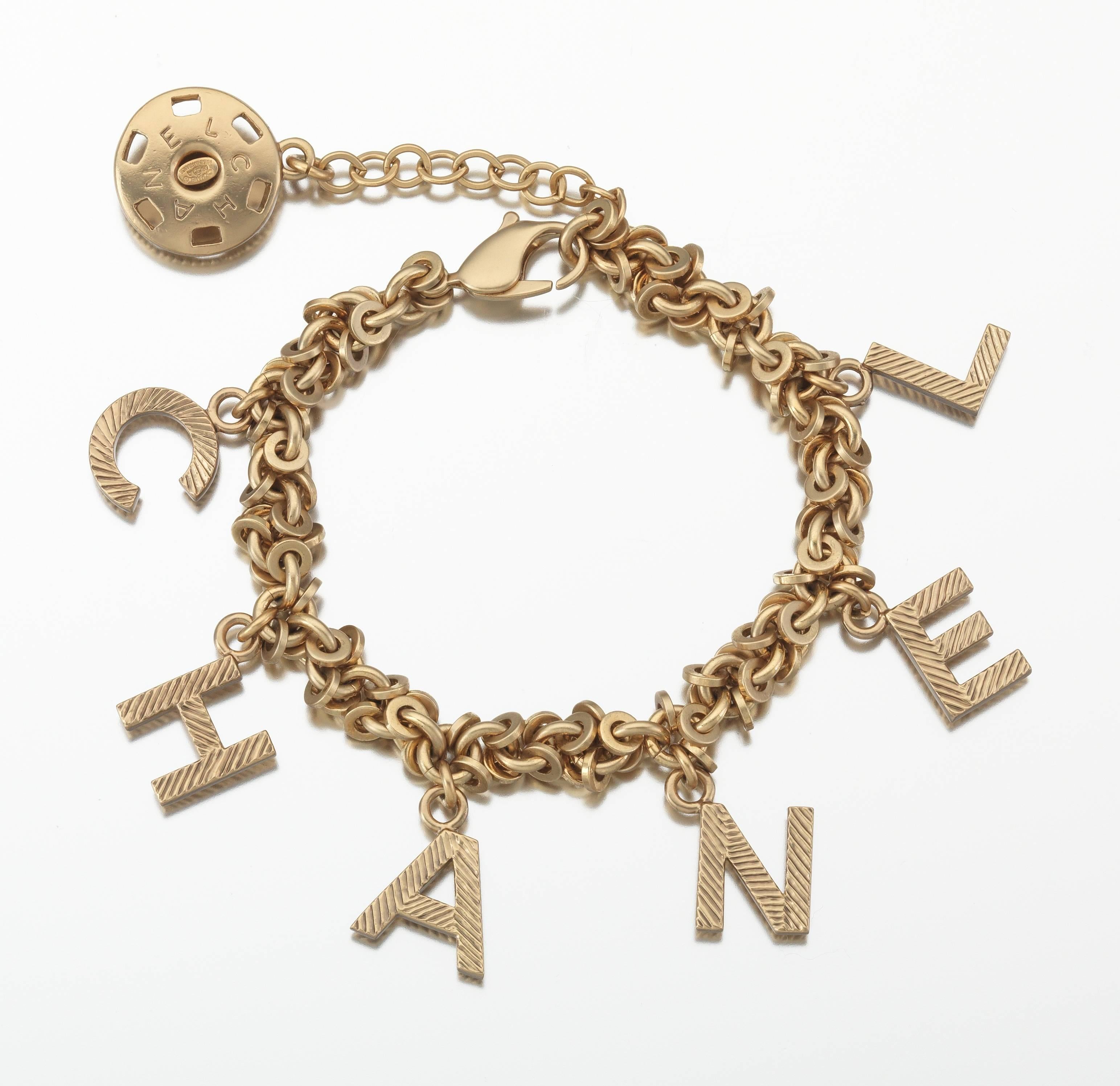 2003A Chanel gold tone linked charm bracelet spelling out the word 