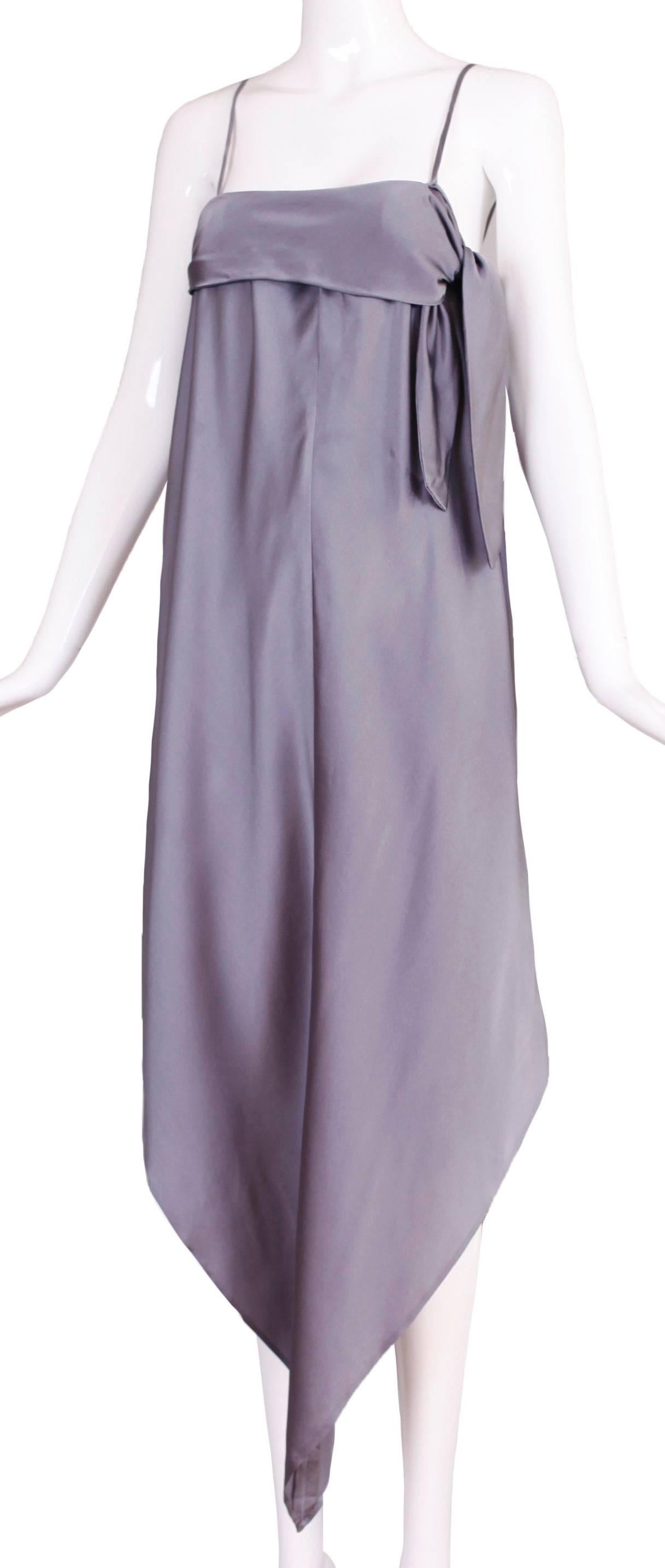 A circa 1974 Pauline Trigere steel grey silk charmeuse 2-piece gown comprised of a strapless gown with handkerchief hem and side tie, and a matching grey silk charmeuse underskirt. In excellent condition. No size tag so please consult