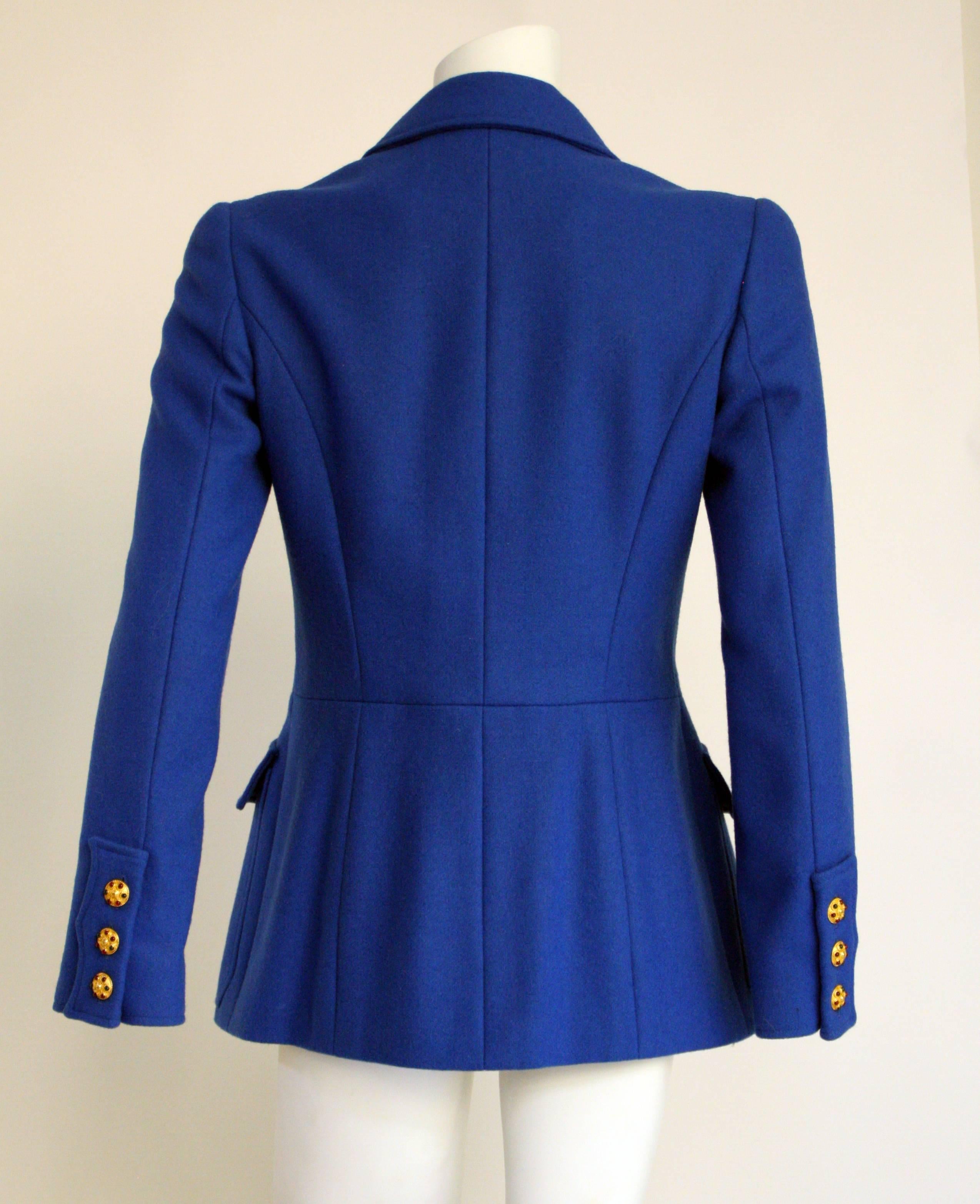A 1996A Chanel royal blue melton wool jacket with frontal pockets and gold tone gripoix buttons down center front and sleeve cuffs. Features silk CC logo interior lining and gold tone chain at the hem. In excellent condition. Size tag