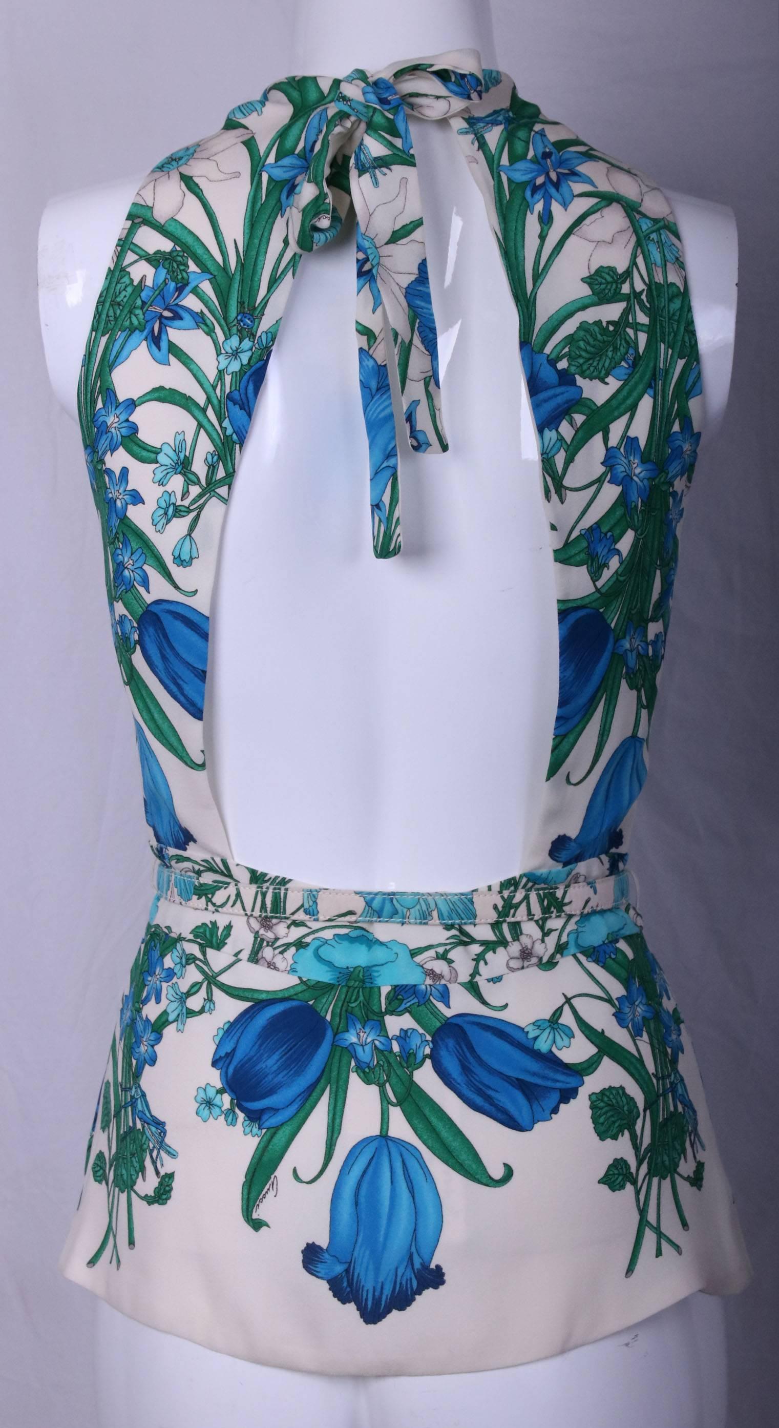 Gucci silk floral print halter top with keyhole neckline, slim waistline belt and open back. Features ties at back neck and side zipper closure. In excellent condition. Size tag 42.
MEASUREMENTS:
Waist - 28