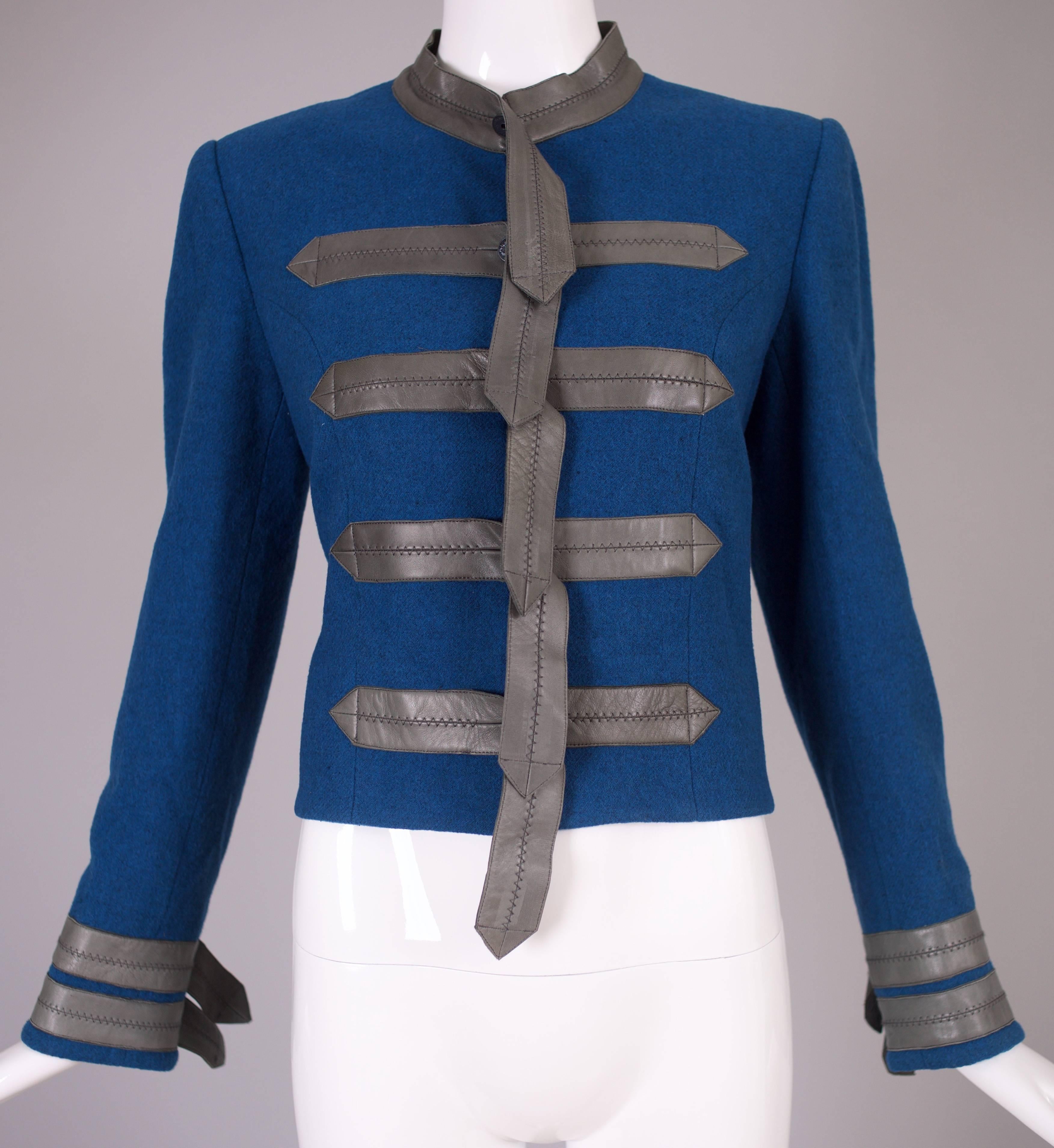 A vintage Loulou De La Falaise blue wool cropped military style jacket decorated with soft lamb leather accents down the front, neckline and at the sleeves. Entirely lined in silk, Size tag 40. In excellent condition.
MEASUREMENTS:
Shoulders - 15