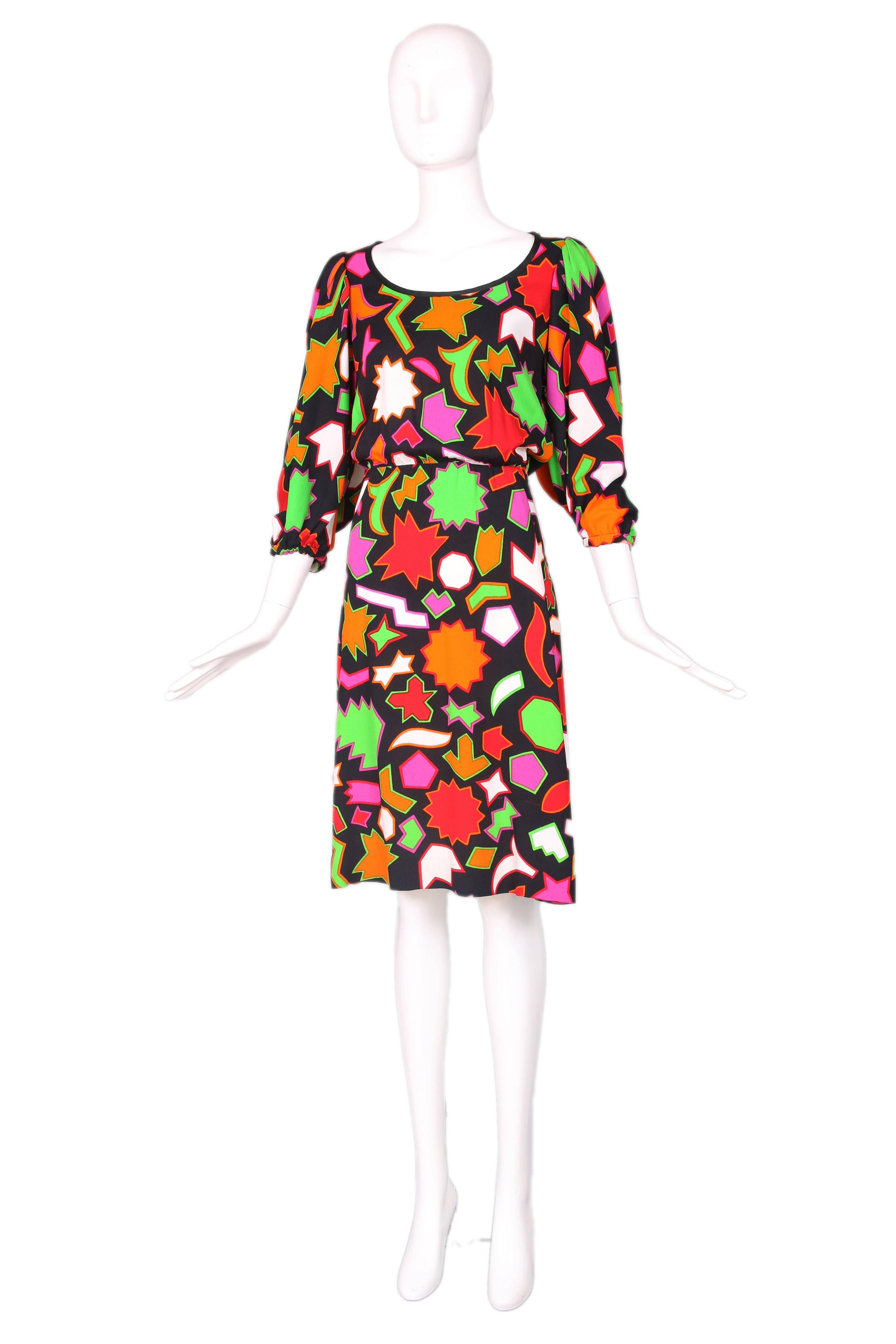 1980'S Yves Saint Laurent crepe day dress with 3/4 balloon sleeves and a multi-colored abstract print in purple, red, orange, white, and green on a black background. Features a scoop neck with black trim, flared skirt and a hidden side zipper