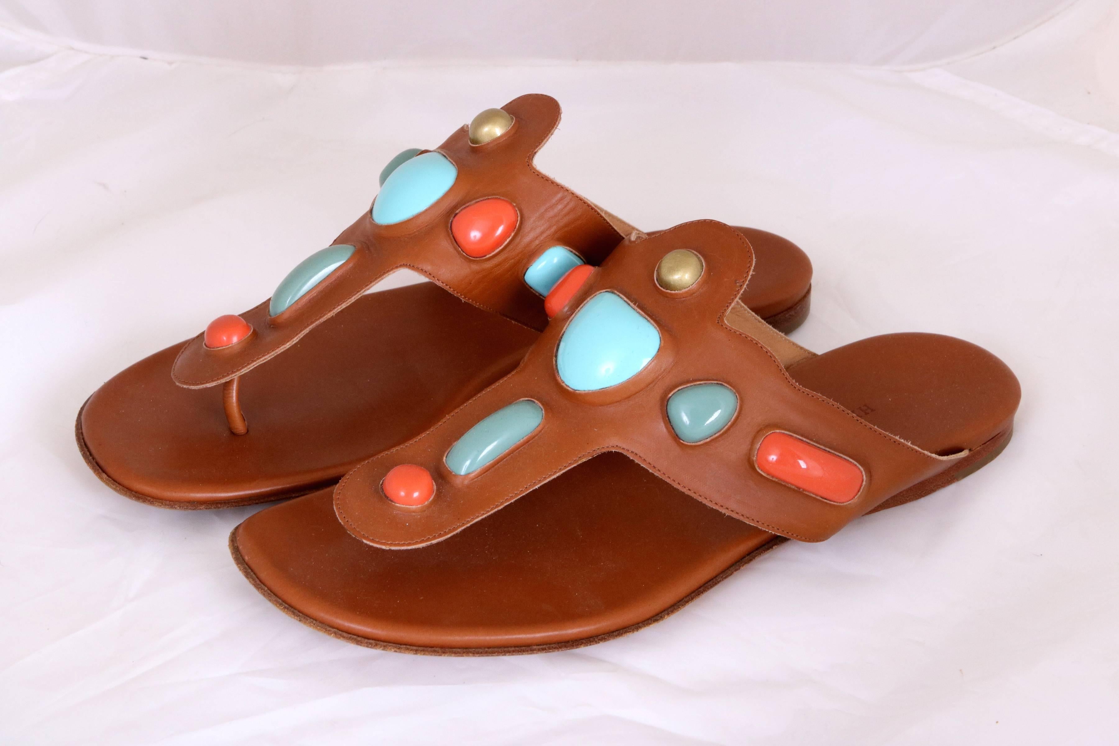 Vintage Hermes camel leather thong sandals with gold, turquoise & orange inset stones. In very good condition.
Size: 38EU
Measurements: 
Heel to toe 10