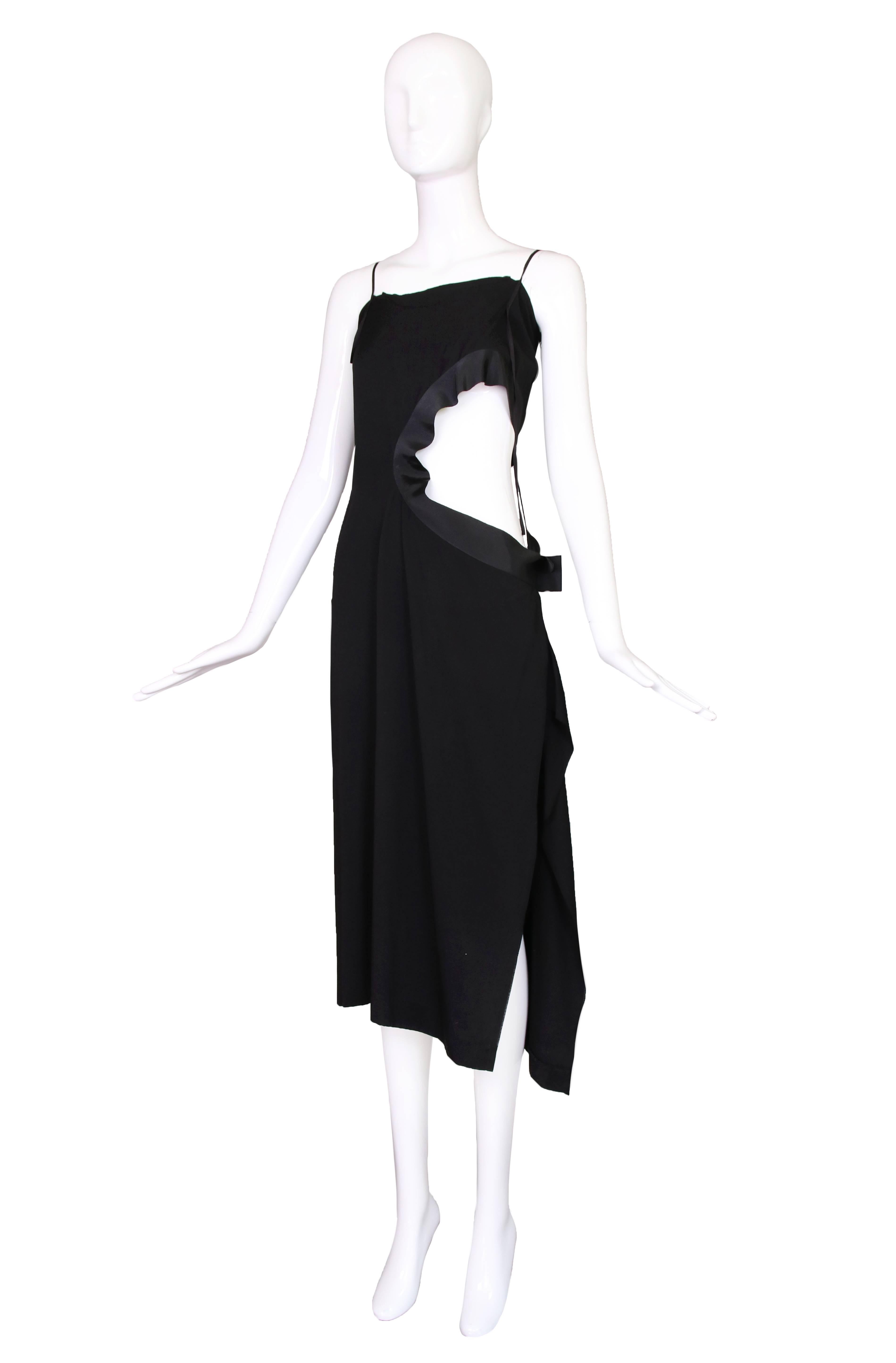 Circa 1990 Yohji Yamamoto black rayon crepe dress with mid-section cutout trimmed with grosgrain ribbon. In excellent condition. Size 1.