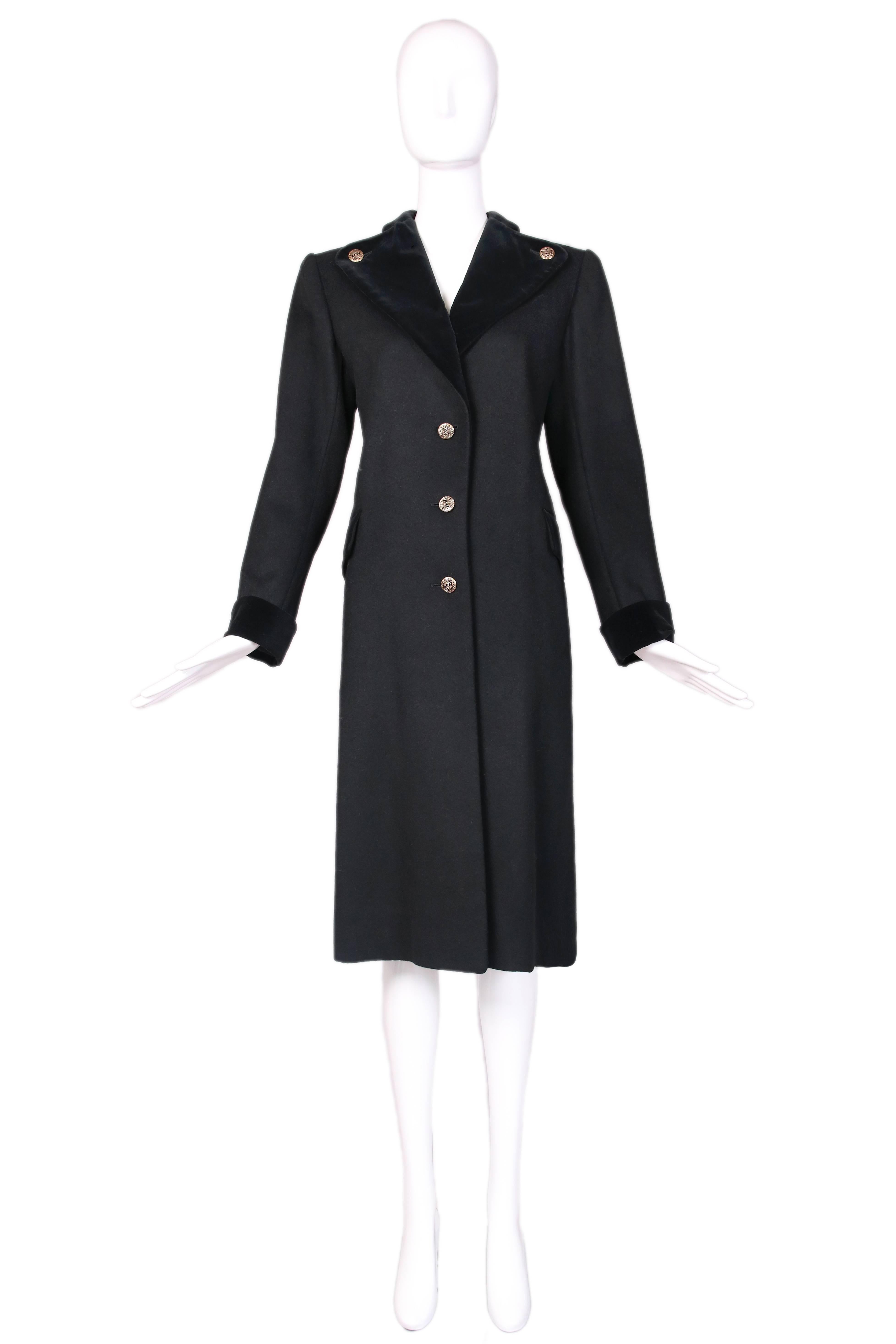 Vintage Yves Saint Laurent black melton wool military style coat with velvet trim and decorative gold tone buttons. In excellent condition. Size 40.
MEASUREMENTS:
Shoulders - 17