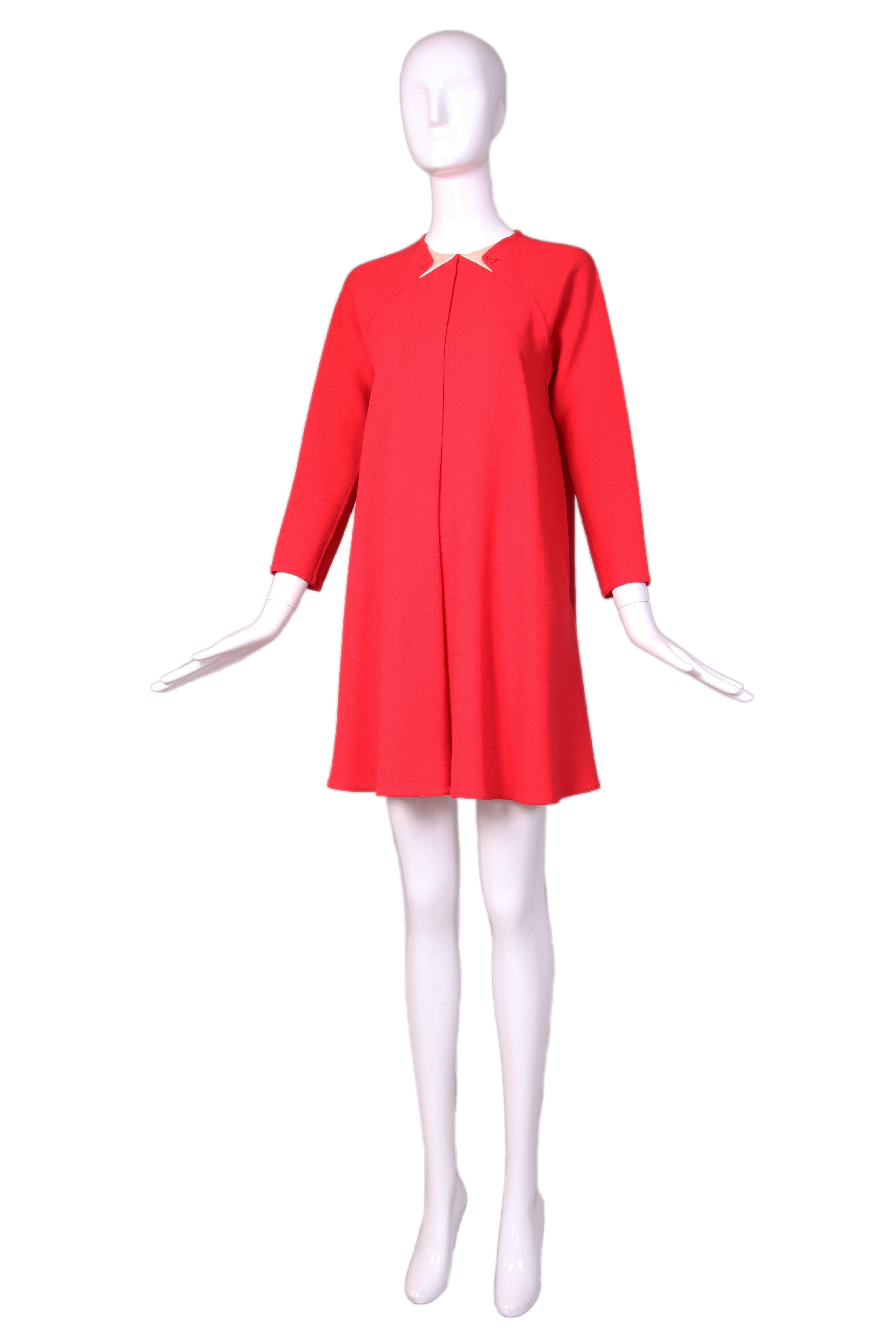 1990's Geoffrey Beene red wool crepe swing dress with signature inlaid geometric collar detail. In excellent condition. No size tag so please consult measurements.
MEASUREMENTS:
Bust - 38